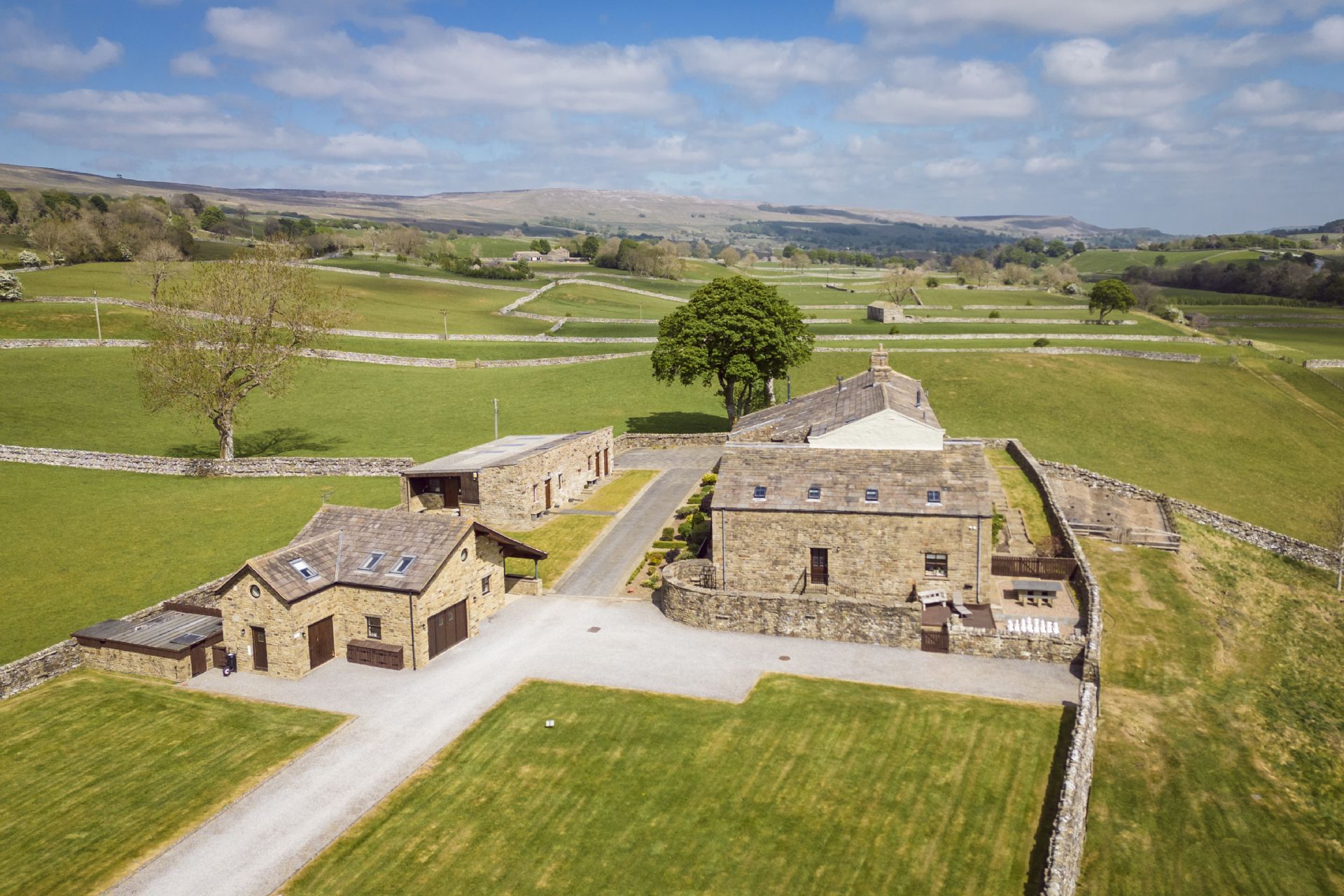 Stone farmhouses and barns in lush Yorkshire countryside