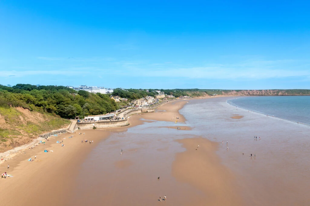 Scarborough beach with sandy shore and distant cliffs