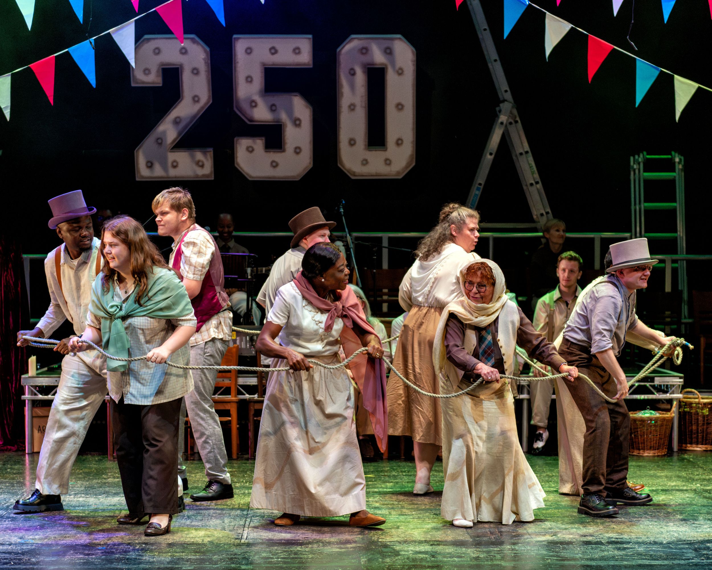 Actors in period costumes perform lively play under bunting