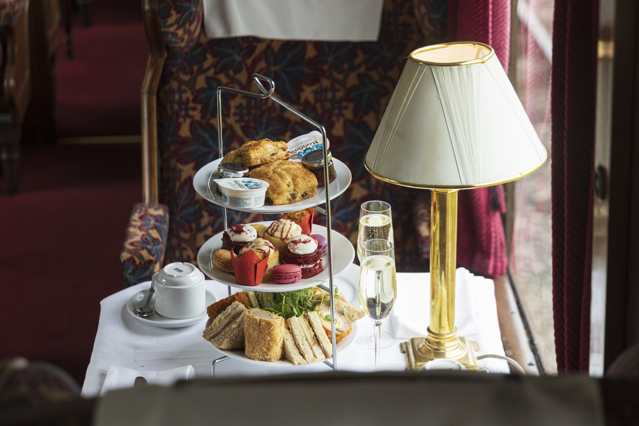 Afternoon tea with sandwiches and pastries on a train