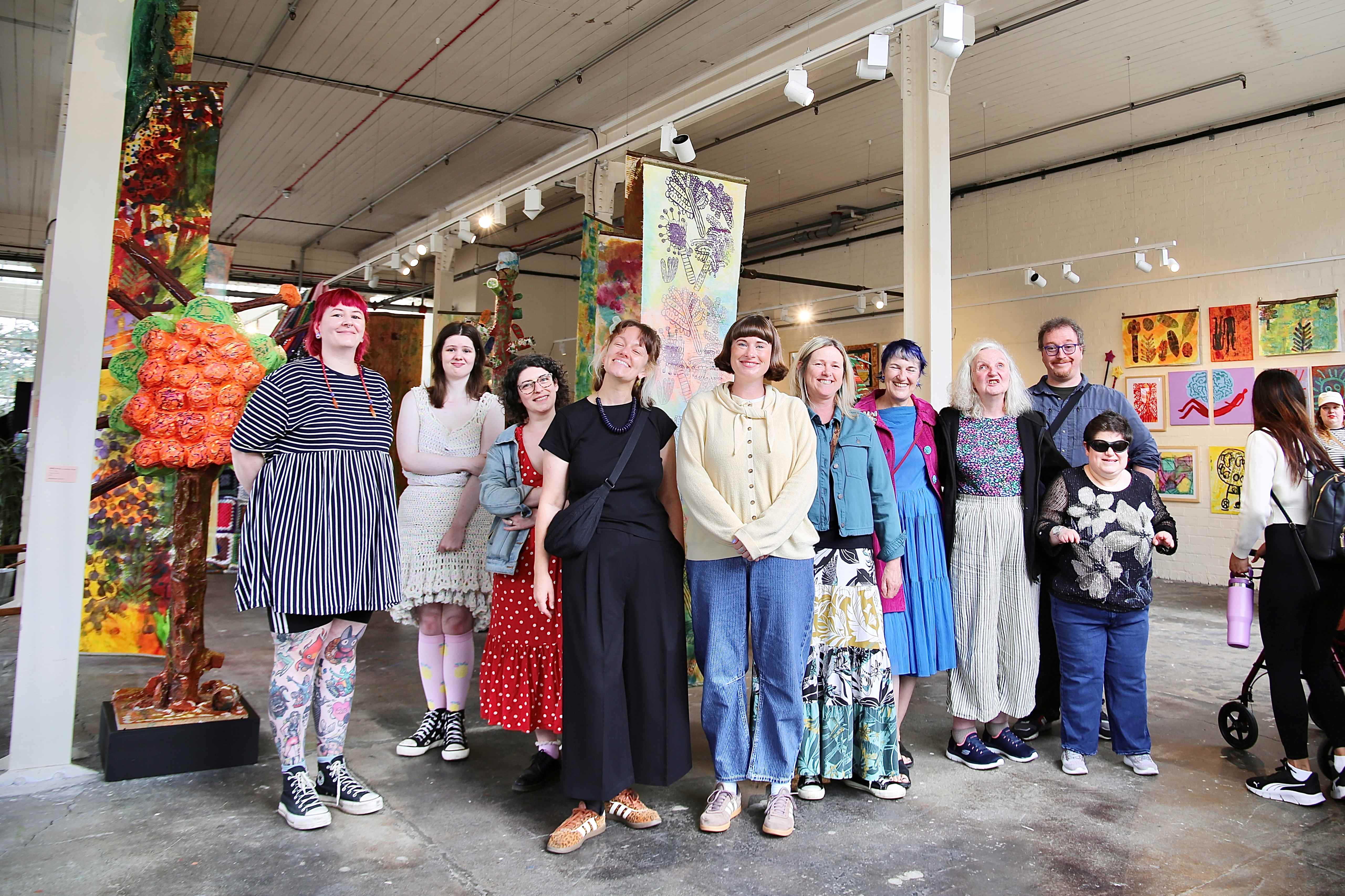 Art gallery visitors standing in front of colorful exhibits