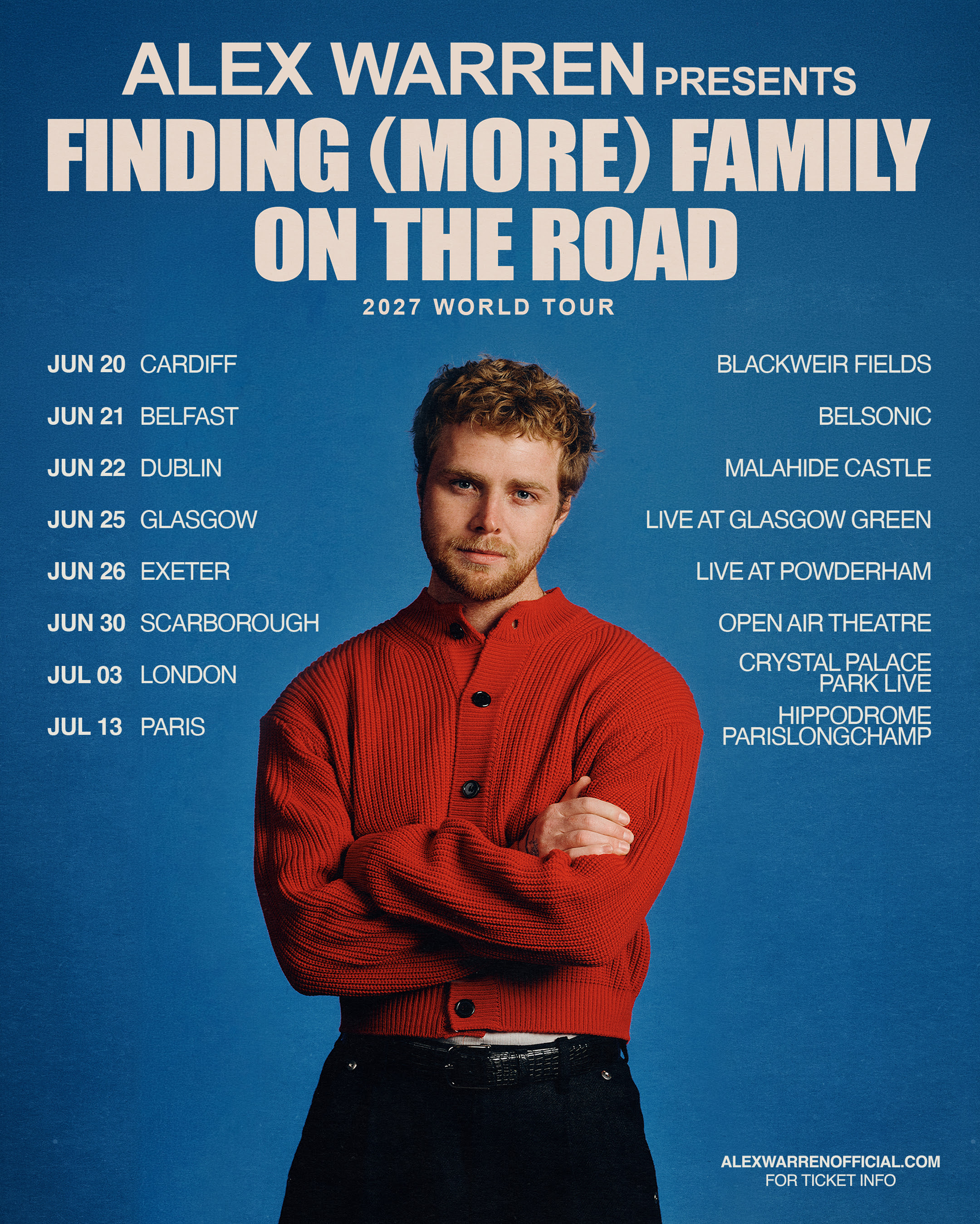 Man in red jumper standing against blue backdrop with tour dates