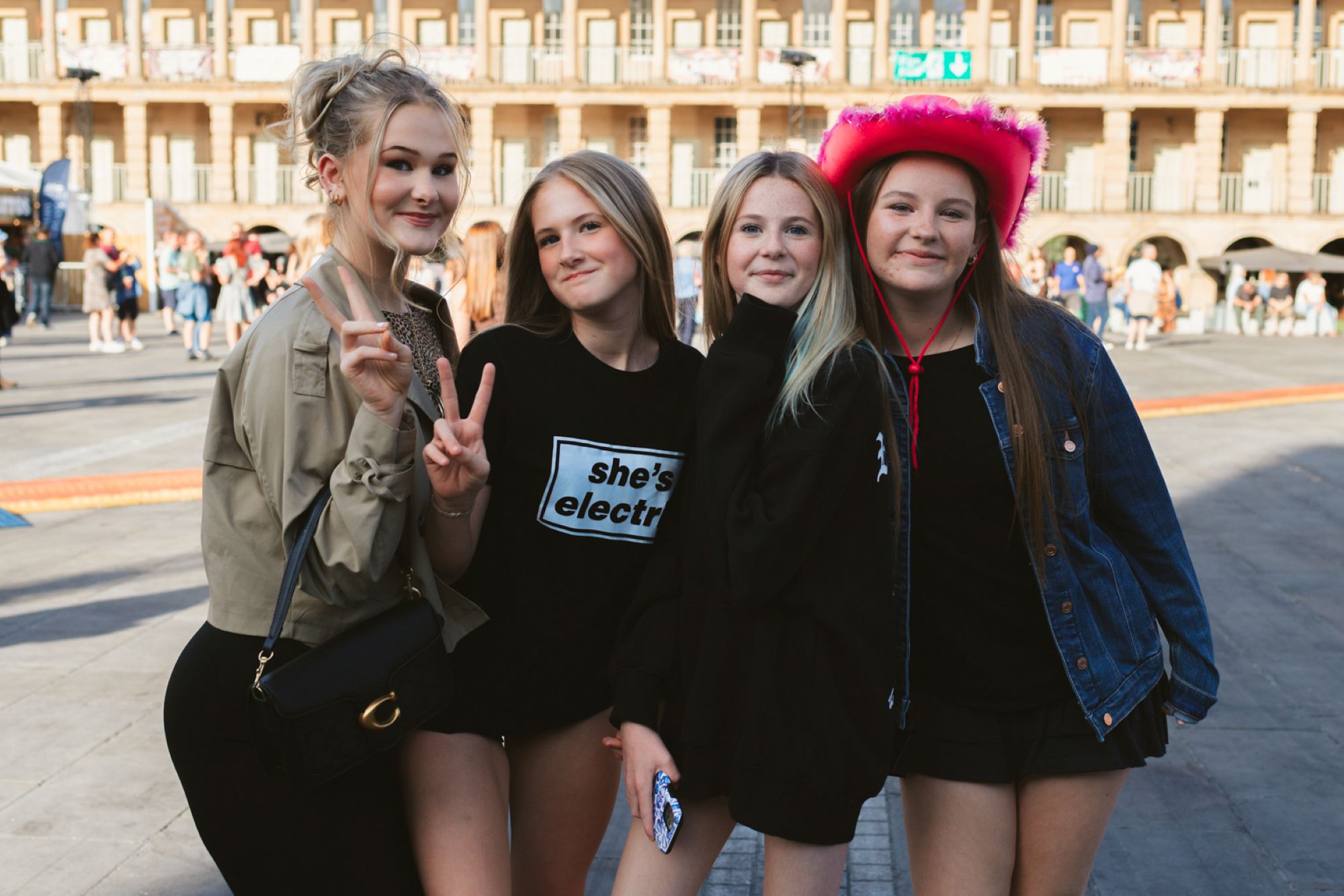 Four young women smiling in front of historic Yorkshire building