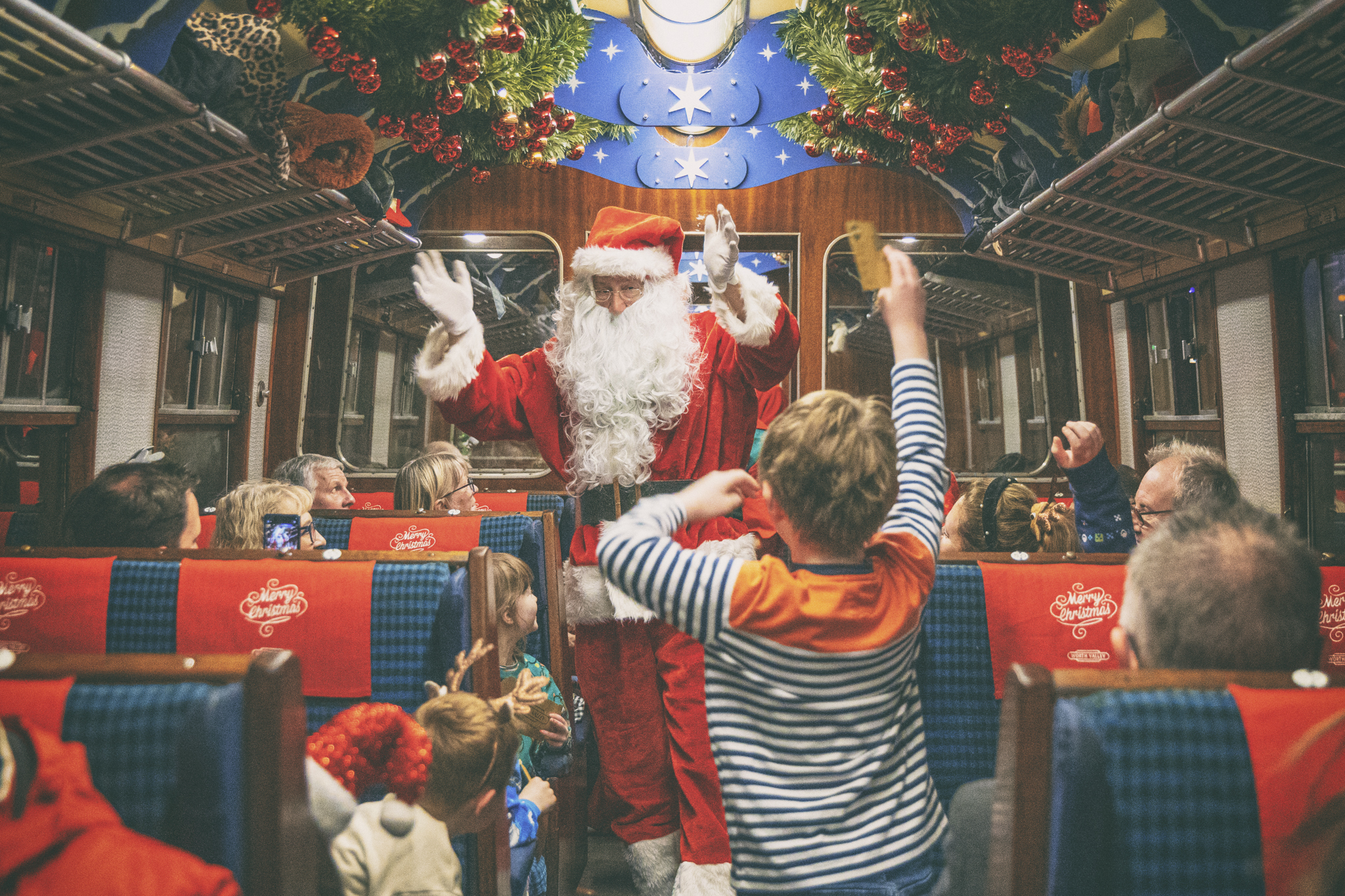 Santa Claus entertaining children on festive train ride