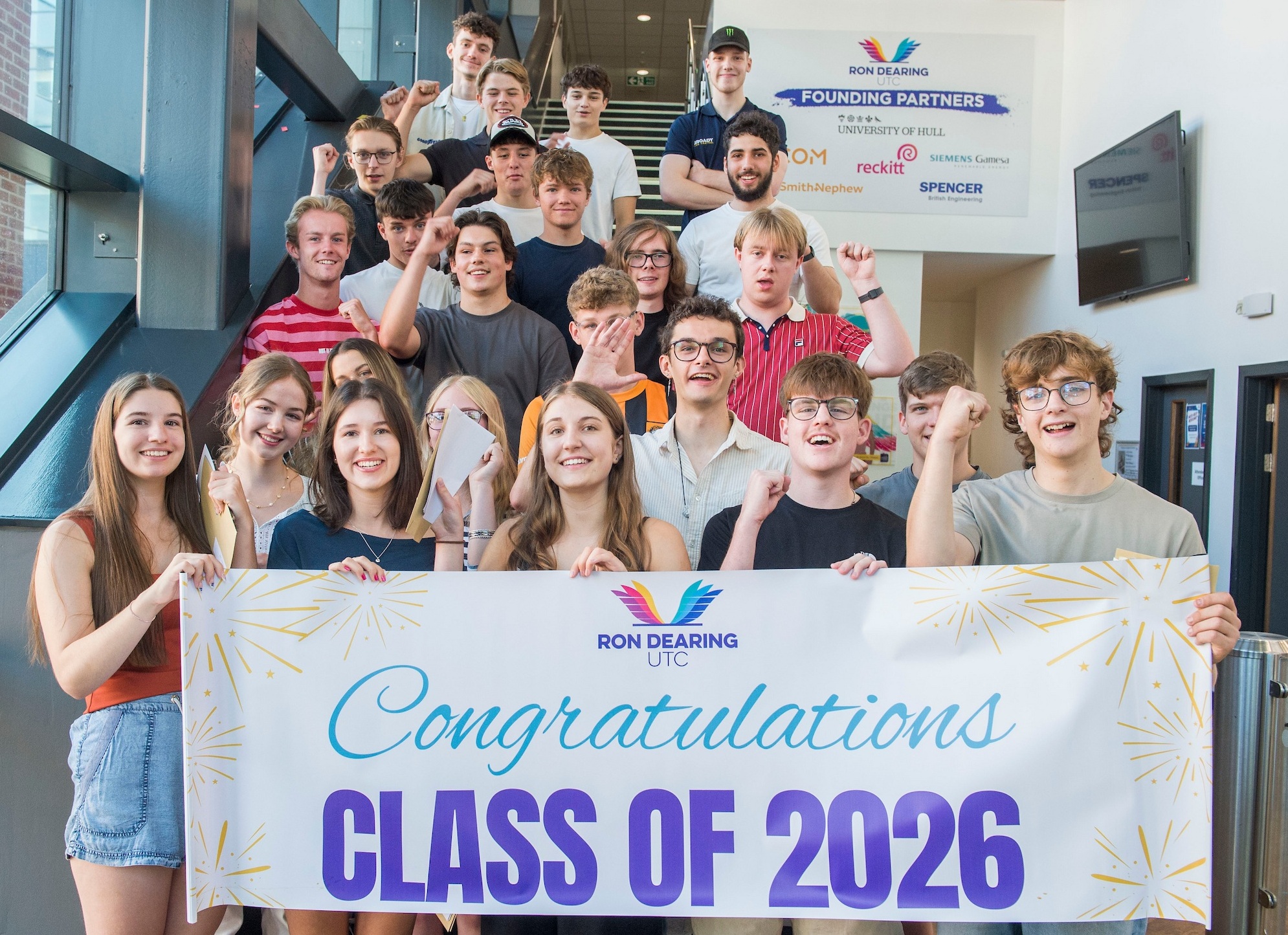 Group of smiling students holding a banner reading 'Class of 2026'