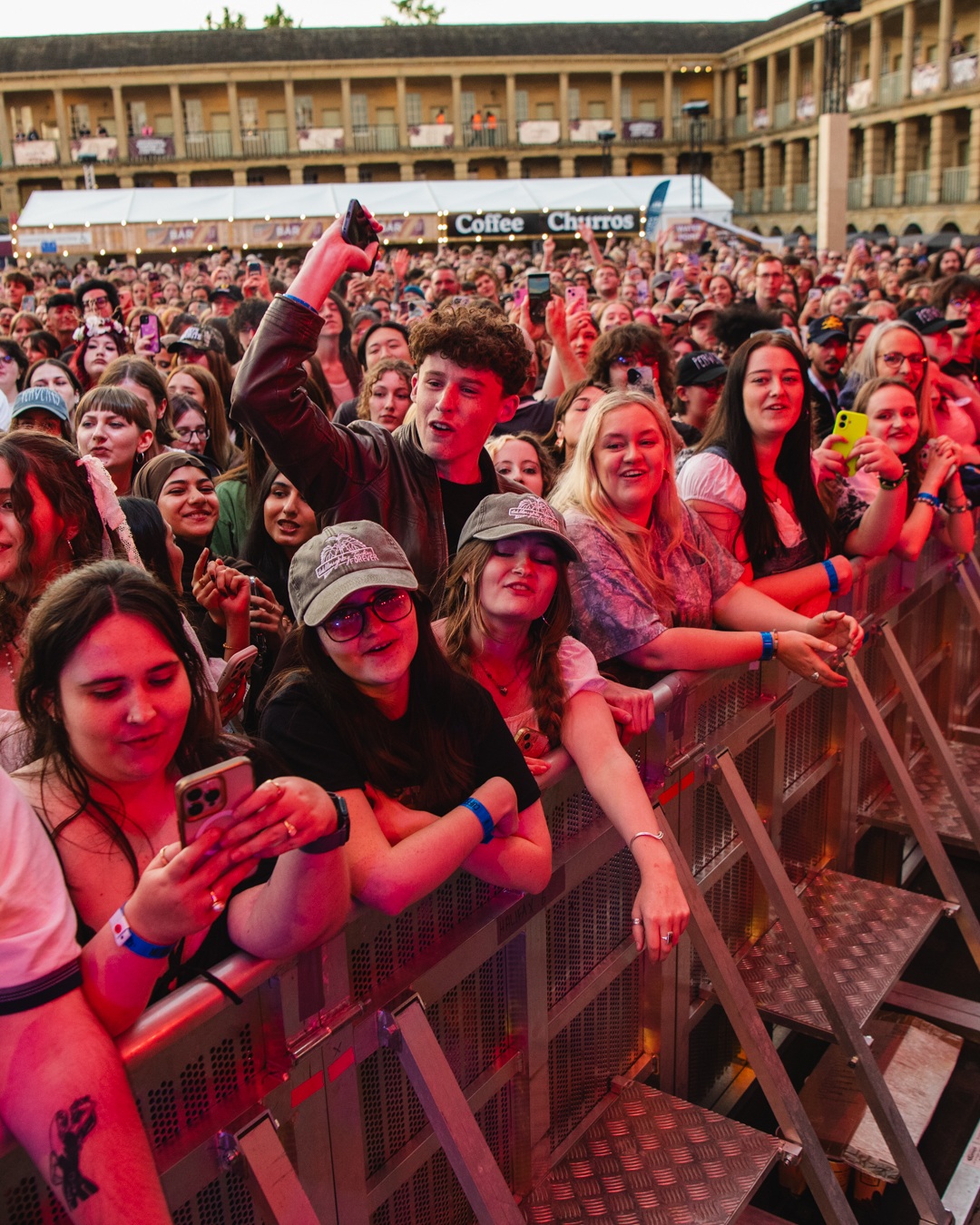 Crowd of excited concertgoers at outdoor music festival