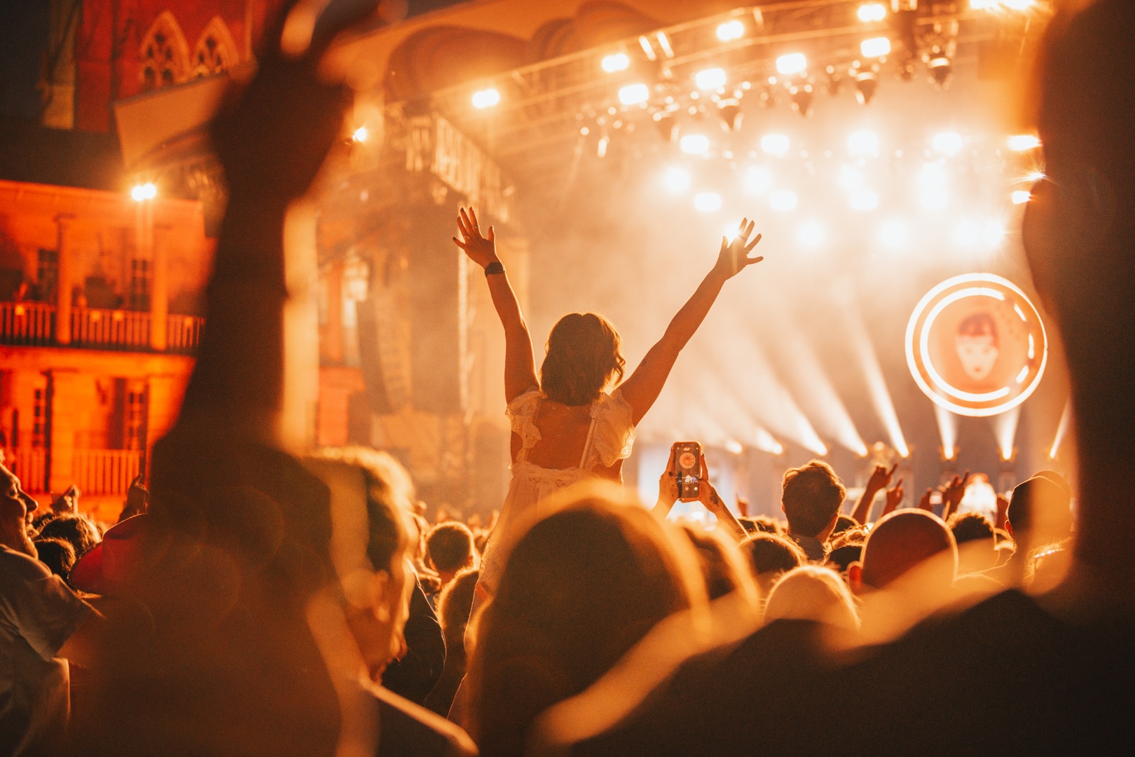 Crowd enjoying a vibrant outdoor music festival at night