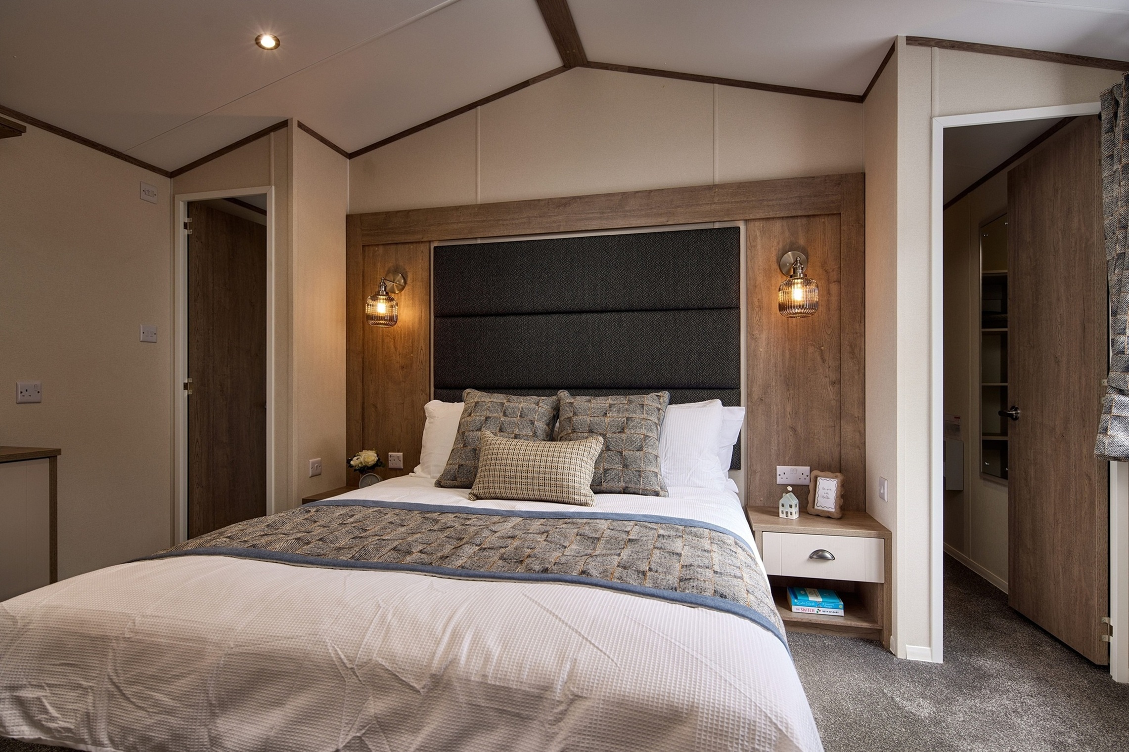 Cosy modern bedroom with wooden accents and soft lighting