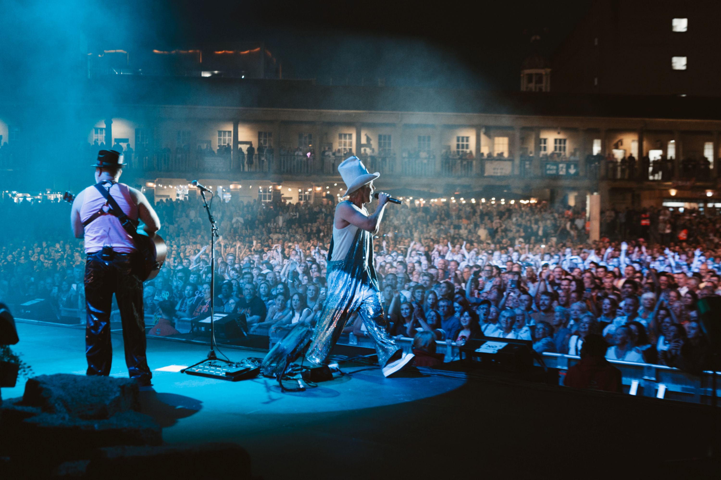 Musician in silver outfit performing on stage at night in Halifax