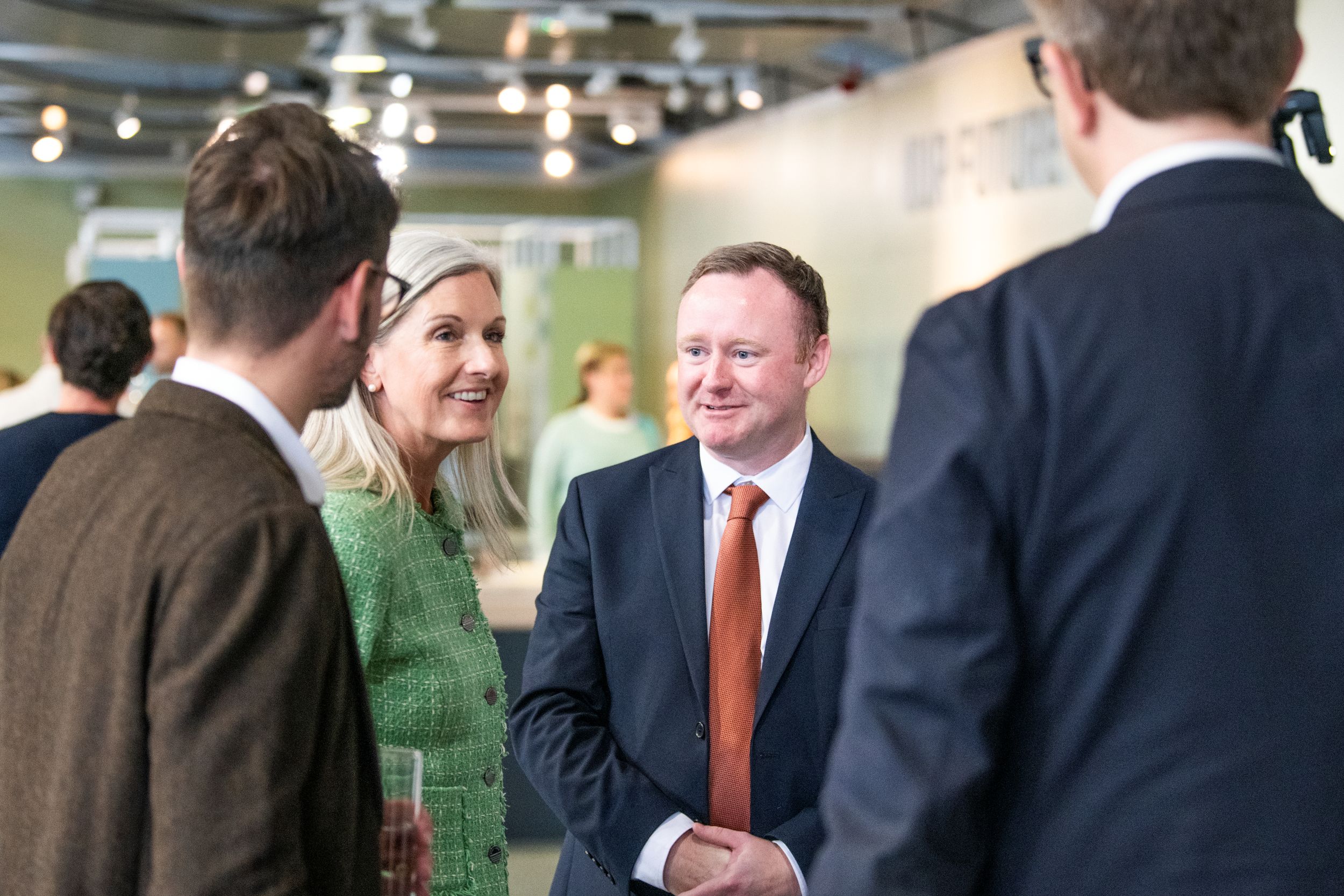 Group of professionals in conversation at a conference
