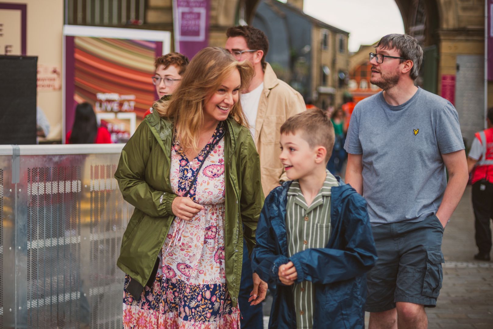 Smiling family walking through a bustling Yorkshire street