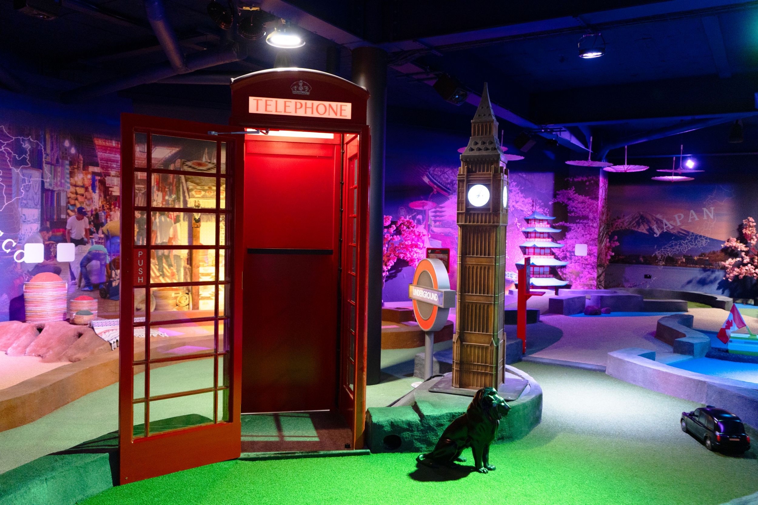 Miniature Big Ben, red telephone box, and dog in indoor exhibit