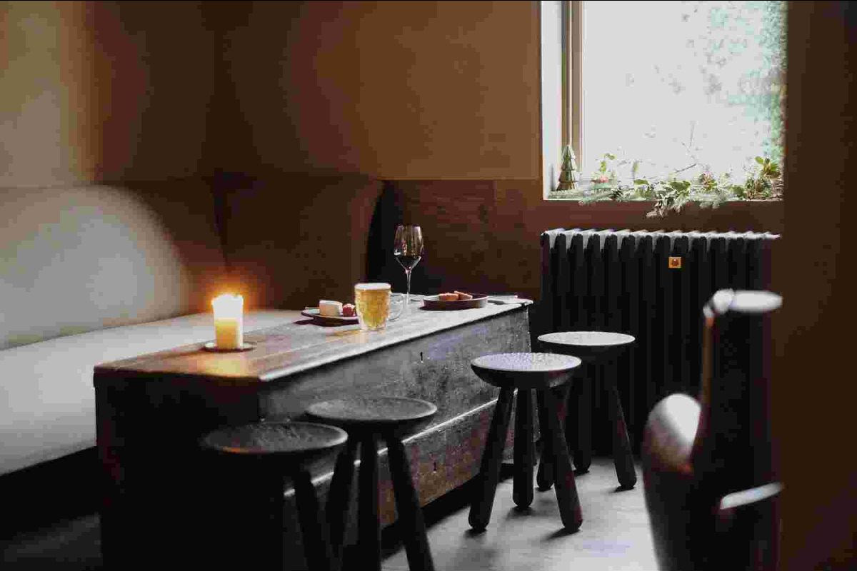 Cozy cafe interior with wooden stools and lit candle