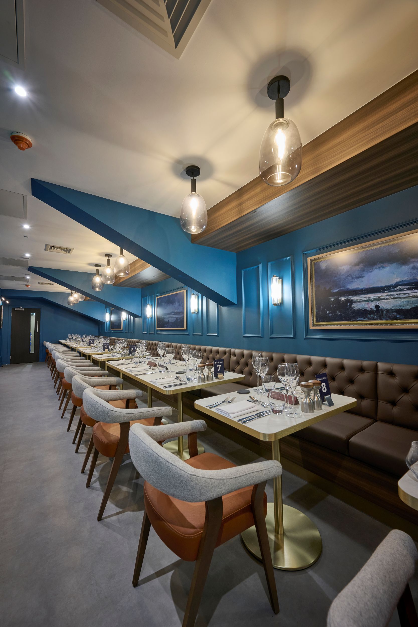 Elegant restaurant interior with blue walls and modern lighting