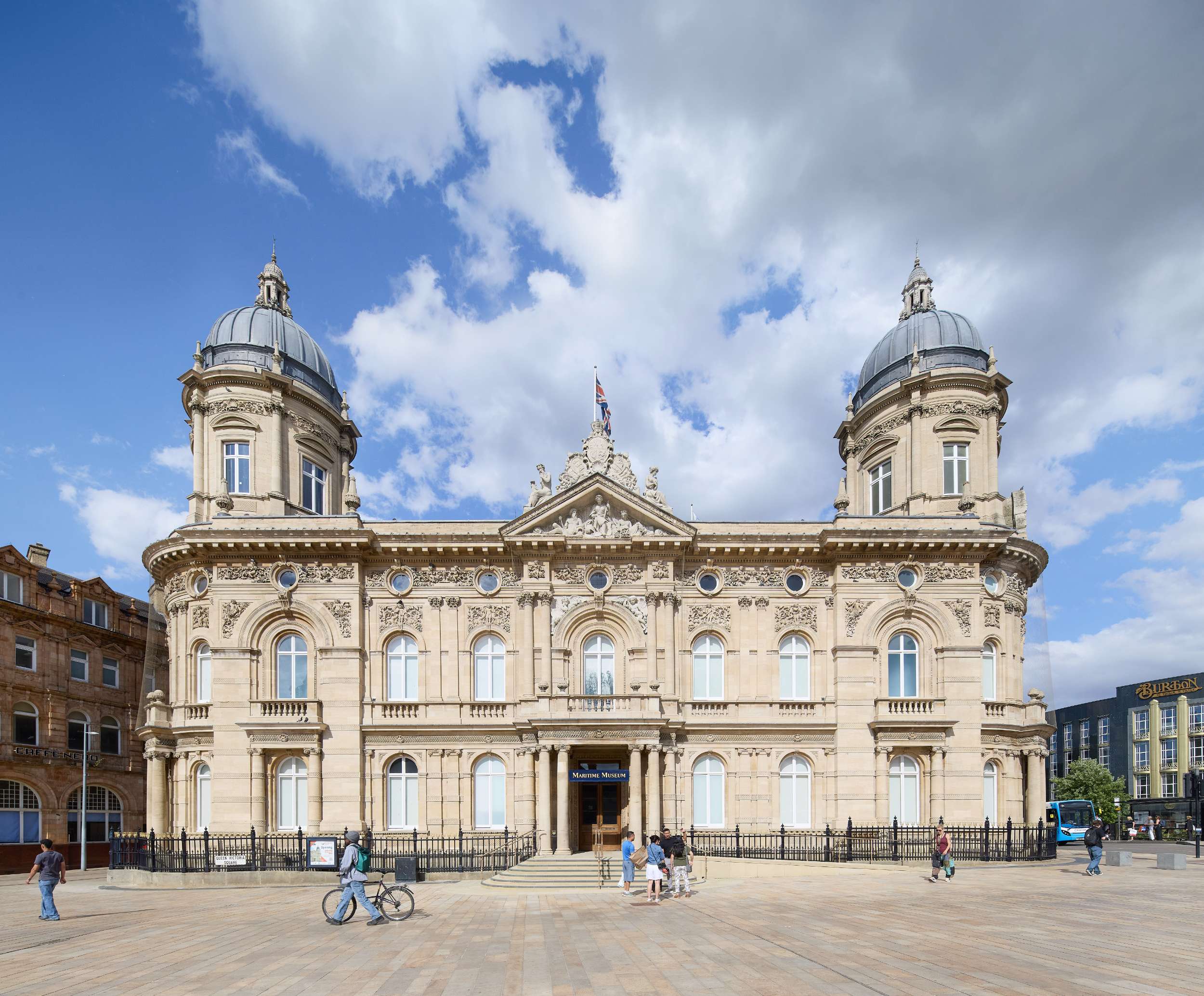 Victorian building with domed turrets under a blue sky