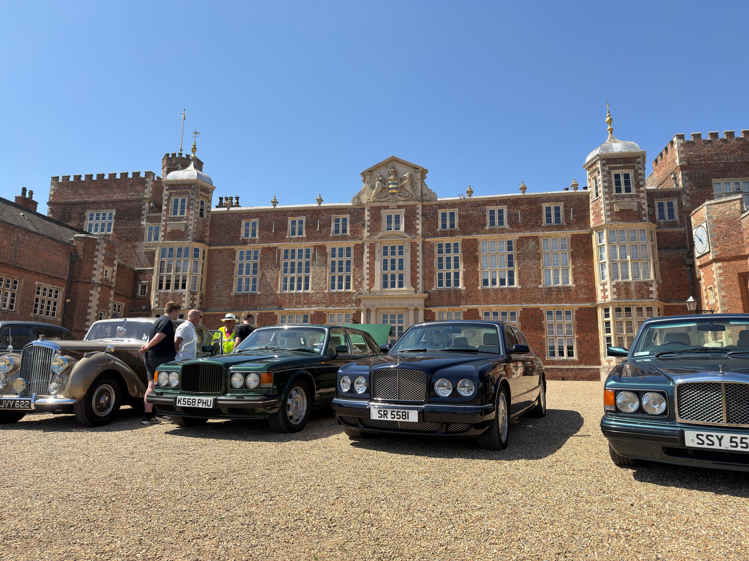 Classic cars parked in front of a grand Yorkshire mansion