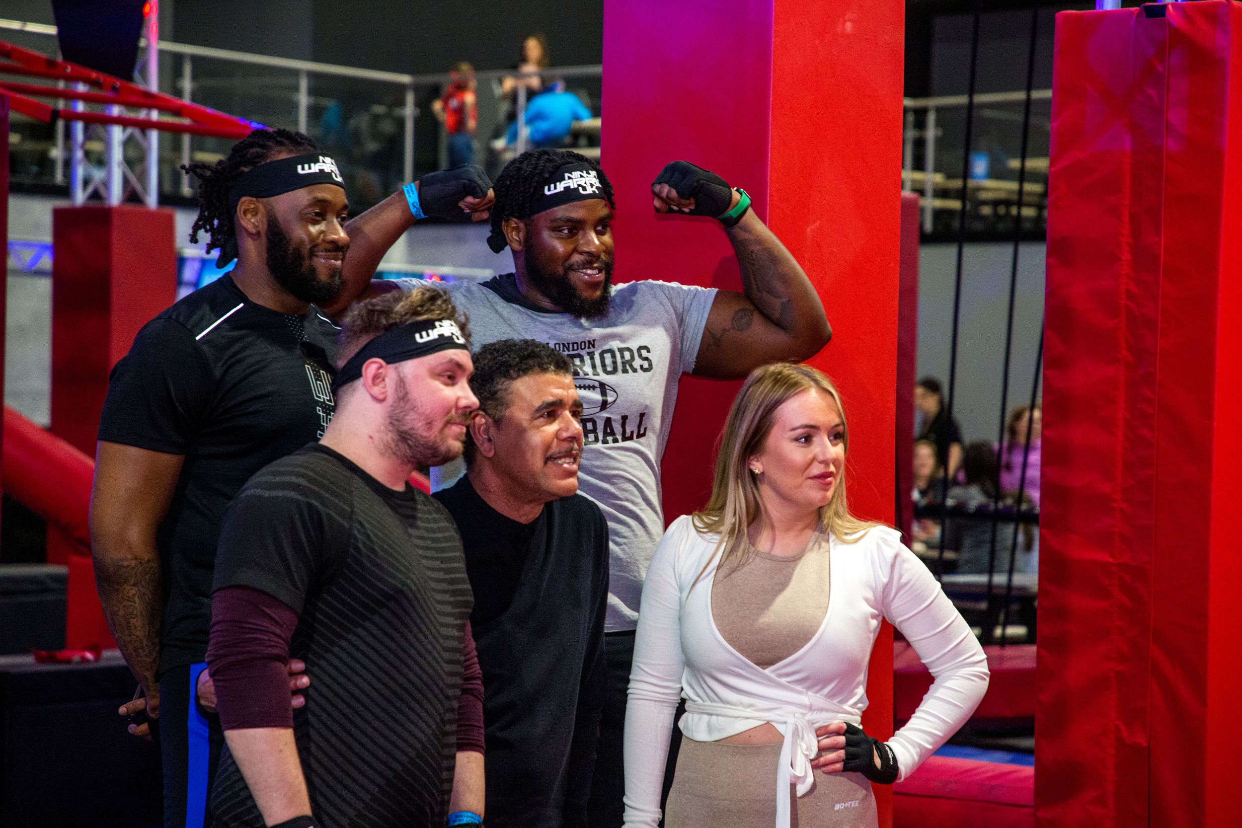 Group of people posing at an indoor obstacle course