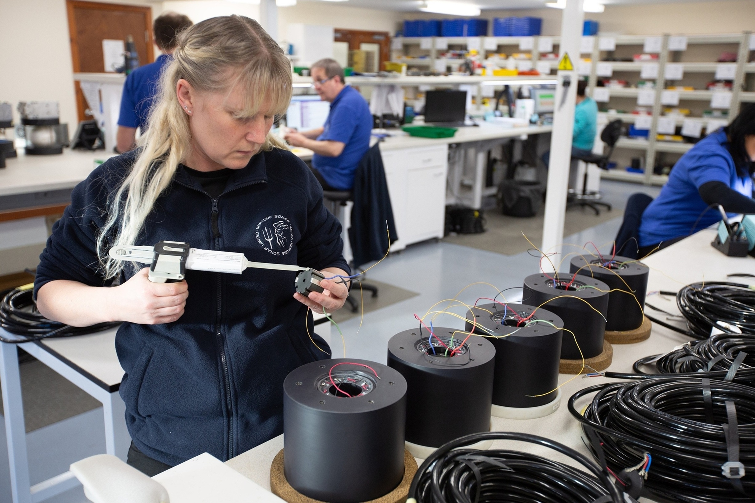 Engineer assembling electronic components in a workshop