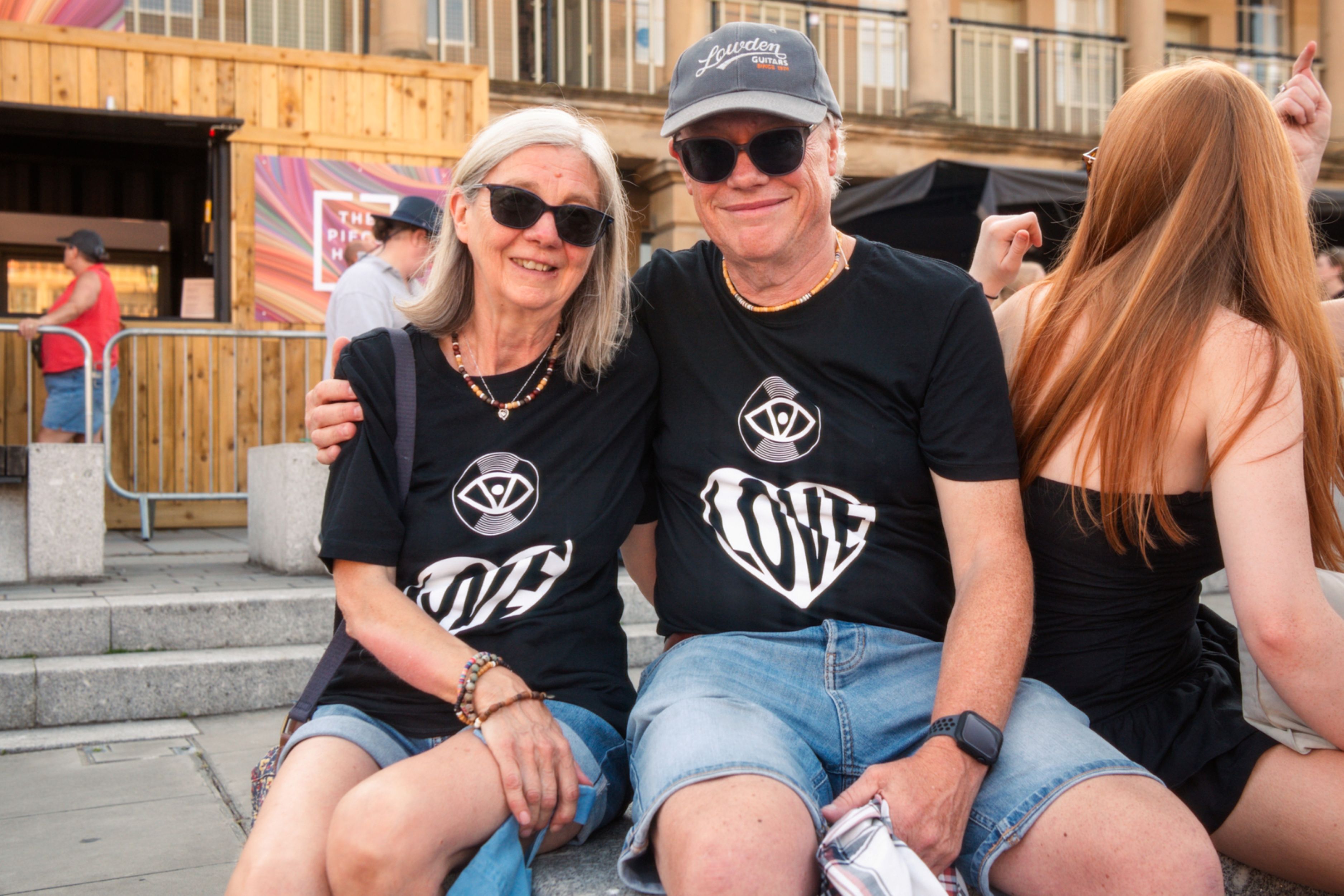 Smiling couple in matching shirts at outdoor festival