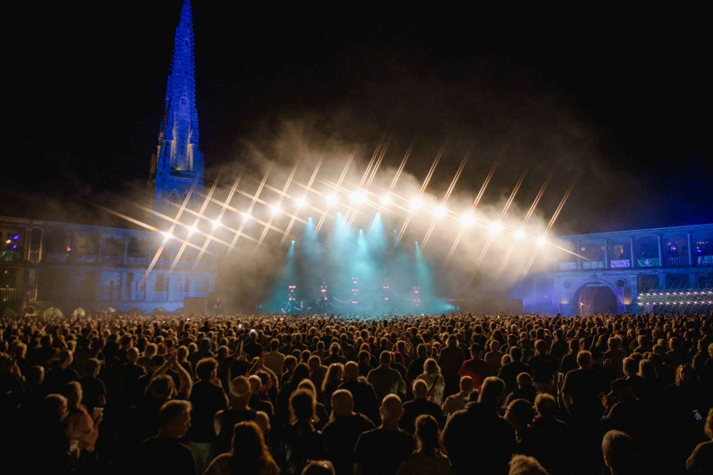 Crowd at night concert in Yorkshire with illuminated stage