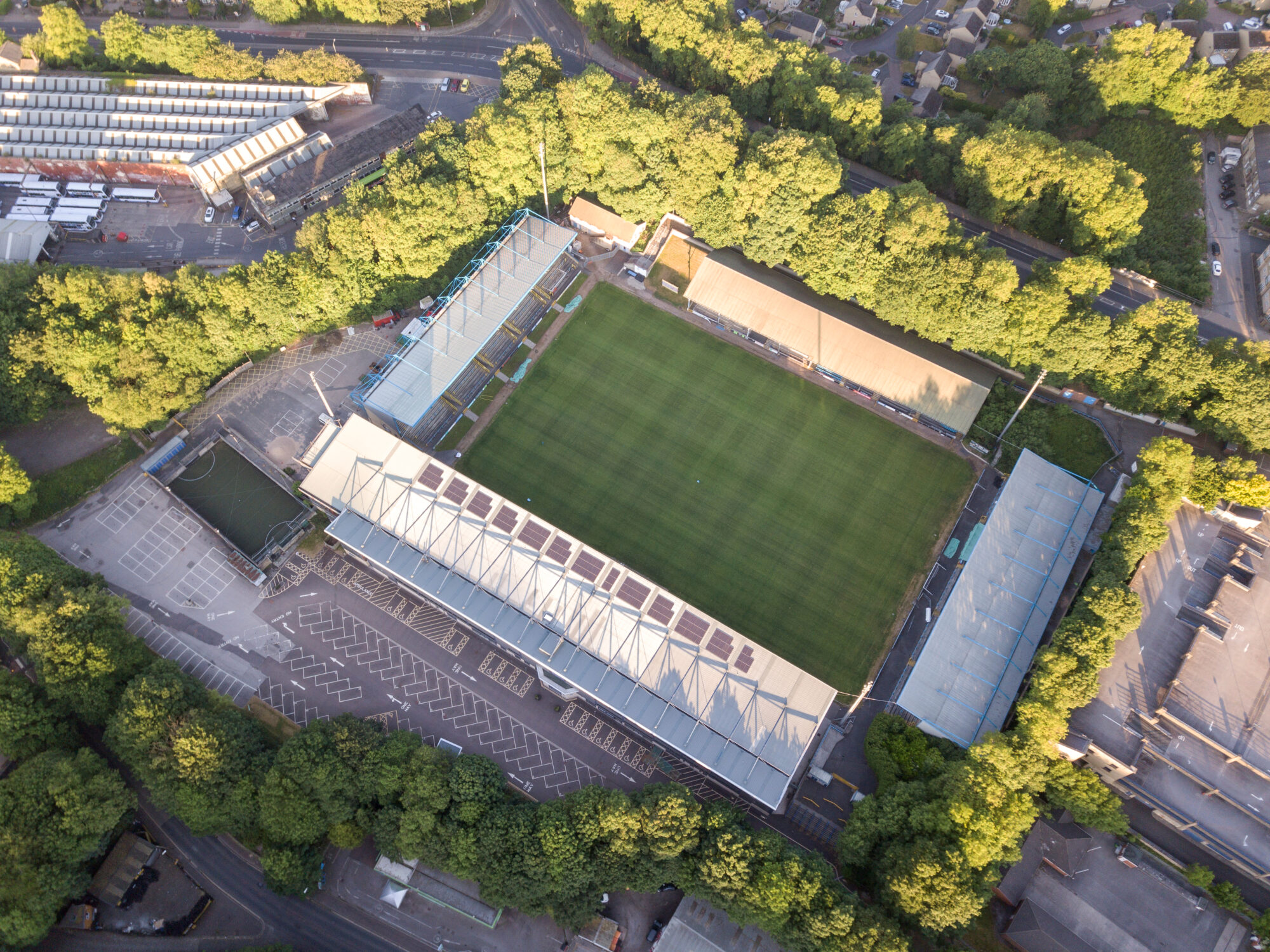 Aerial view of a football stadium surrounded by trees and buildings