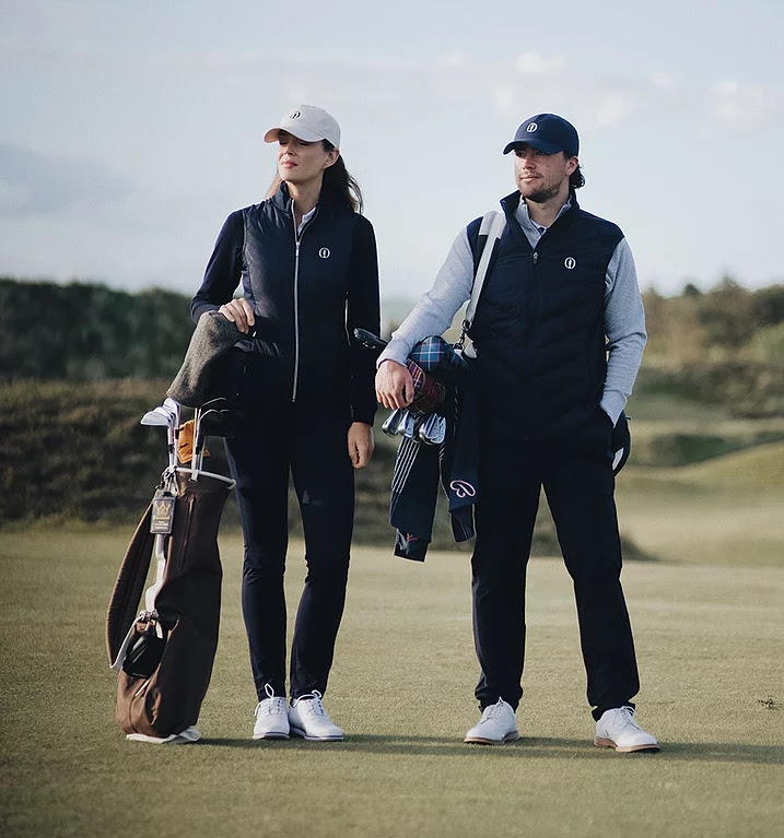 Two golfers in casual attire on a lush green course