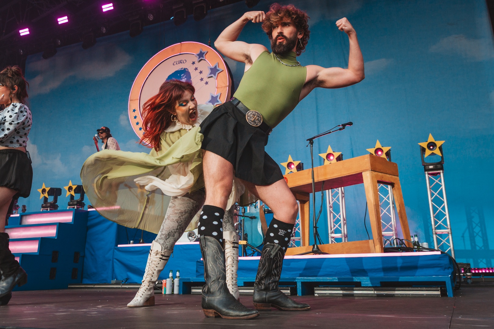 Colourful stage performance with dancers in eclectic costumes