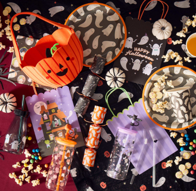 Halloween-themed table setting with ghost plates and pumpkin decor