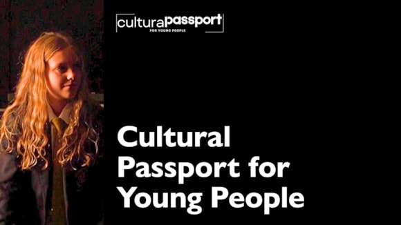 Young person with long hair in a dark setting next to cultural passport text