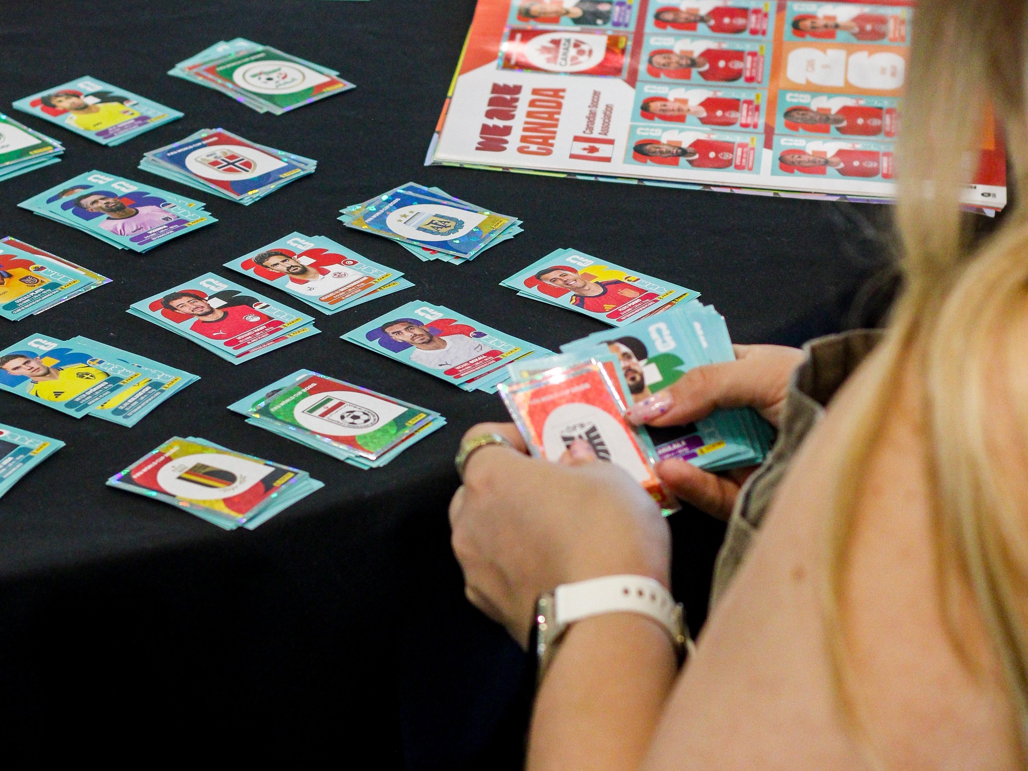 Person sorting collectible football trading cards on table