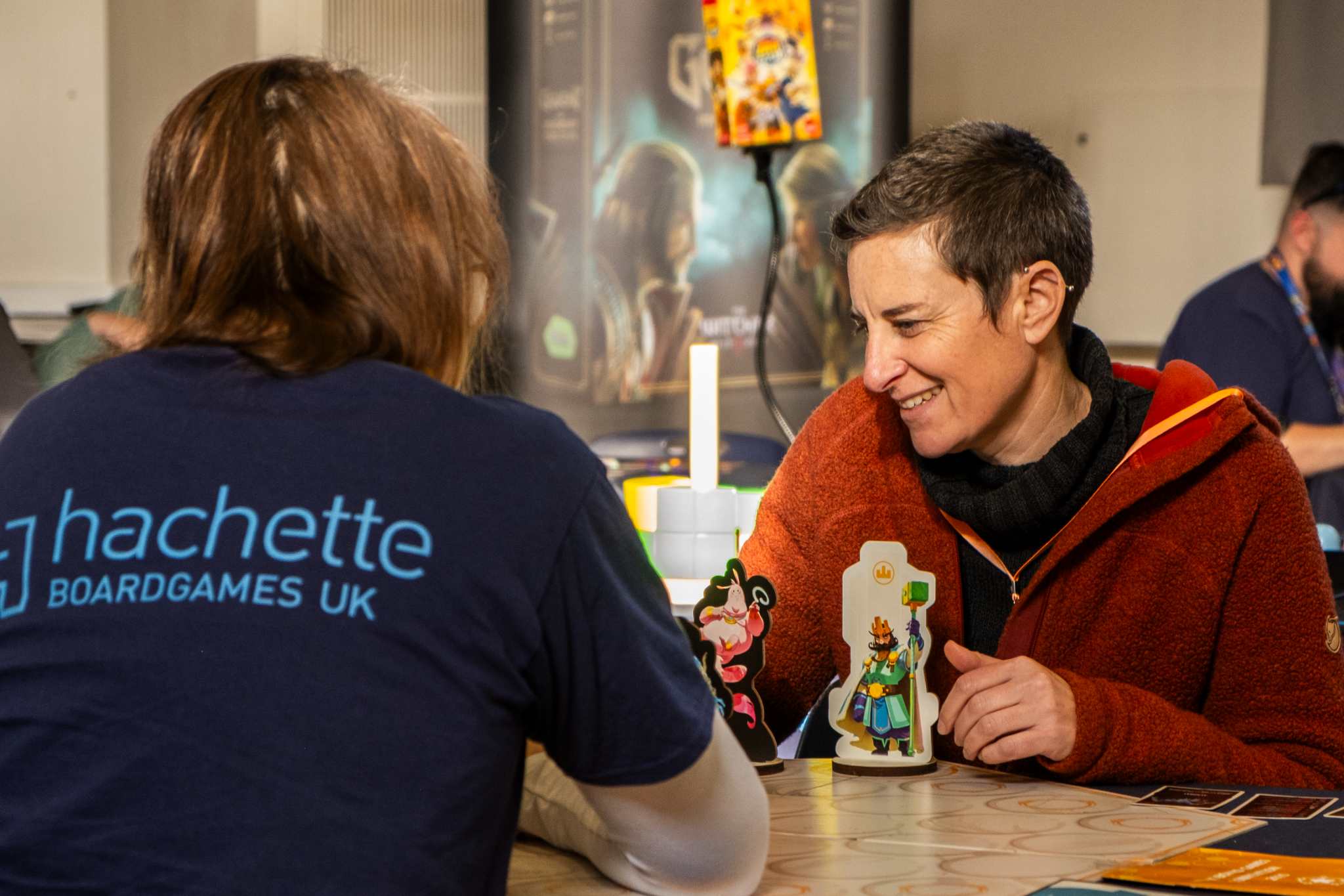 Two people playing board games at a cosy indoor event
