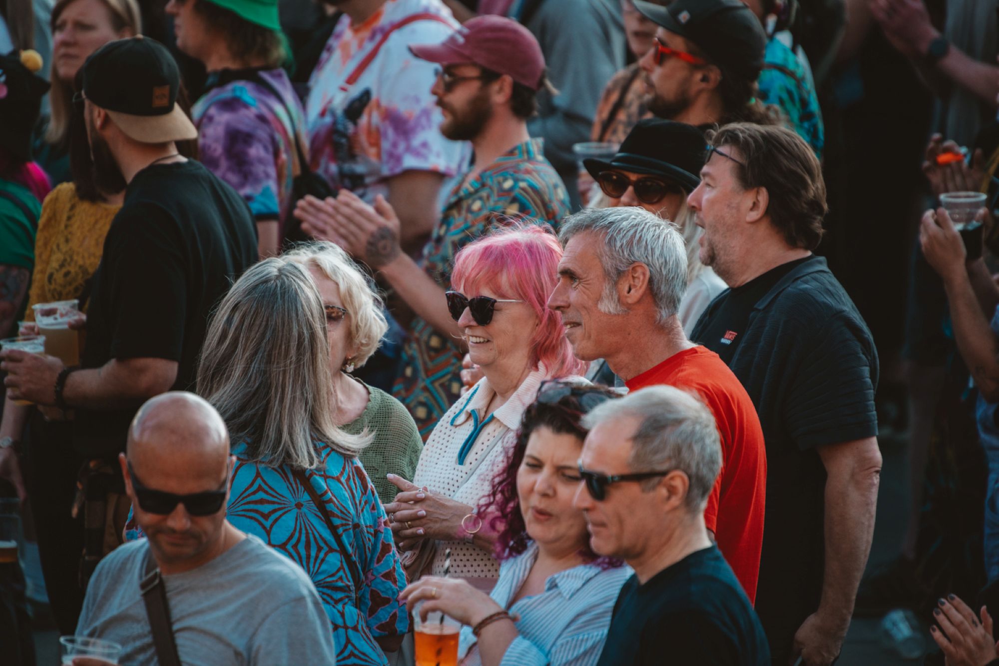 Crowd of diverse people enjoying outdoor festival in casual attire