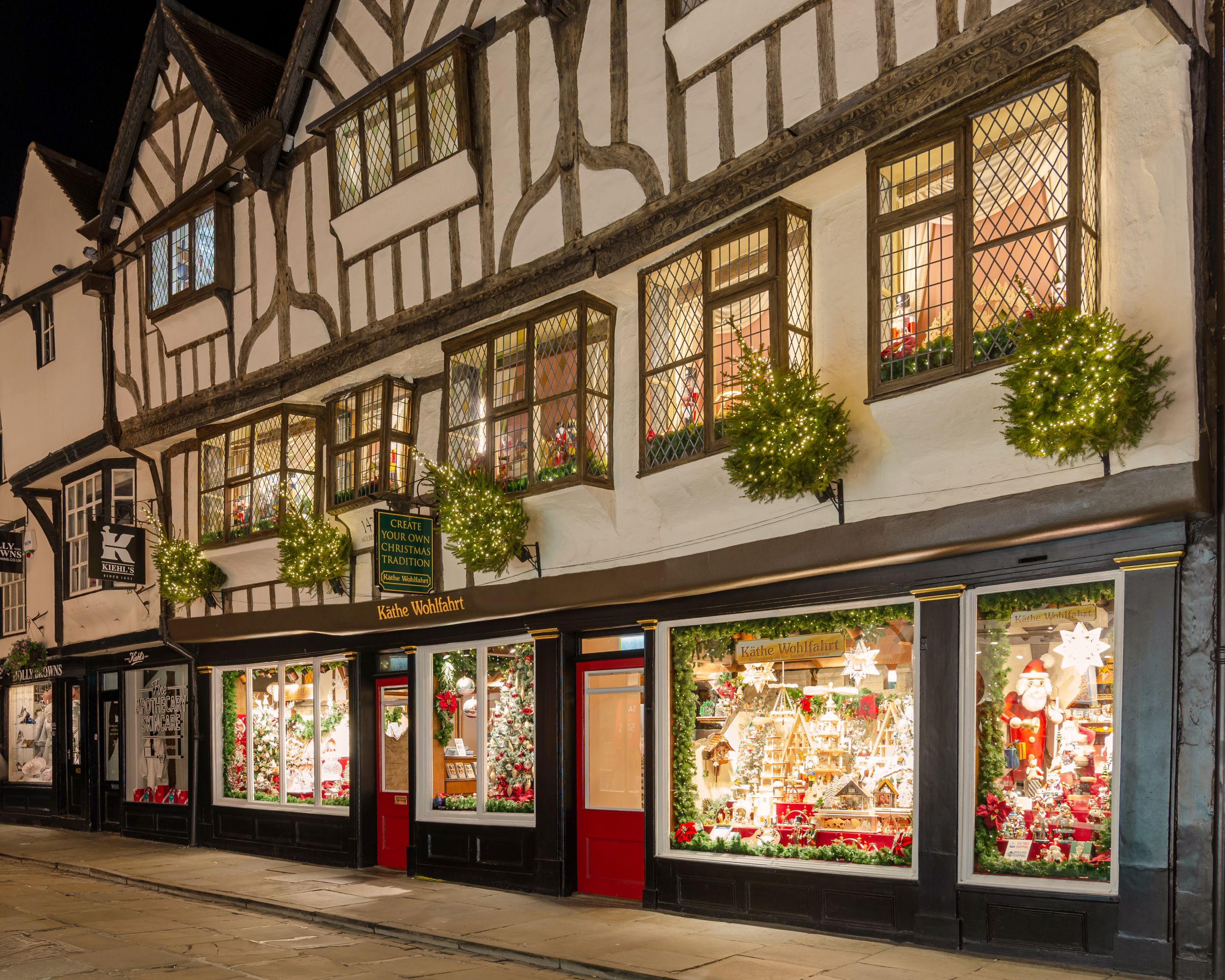 Tudor-style shopfront with festive Christmas window displays