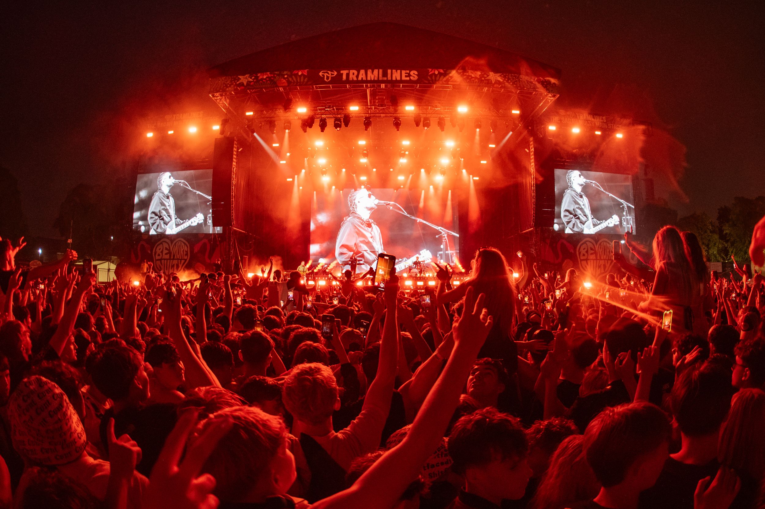Crowd enjoying vibrant evening concert with bright stage lights