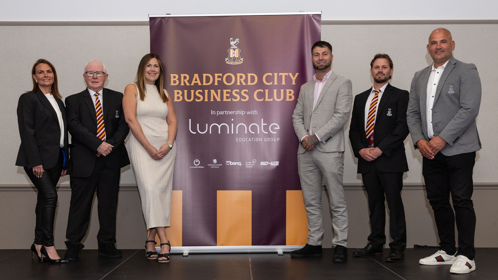 Group of six people in smart attire at Bradford City Business Club event