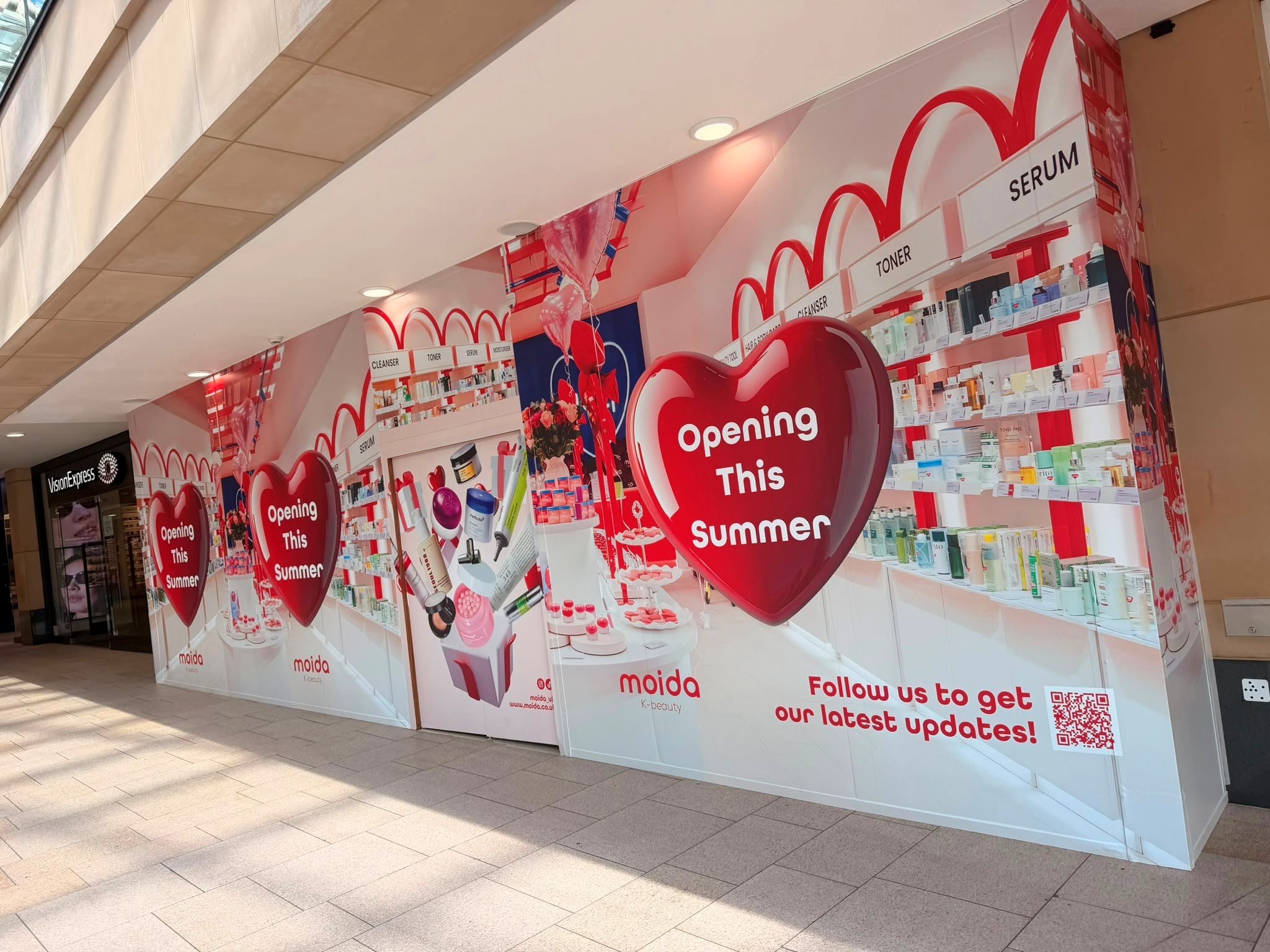 Shopfront with heart-shaped signs announcing summer opening