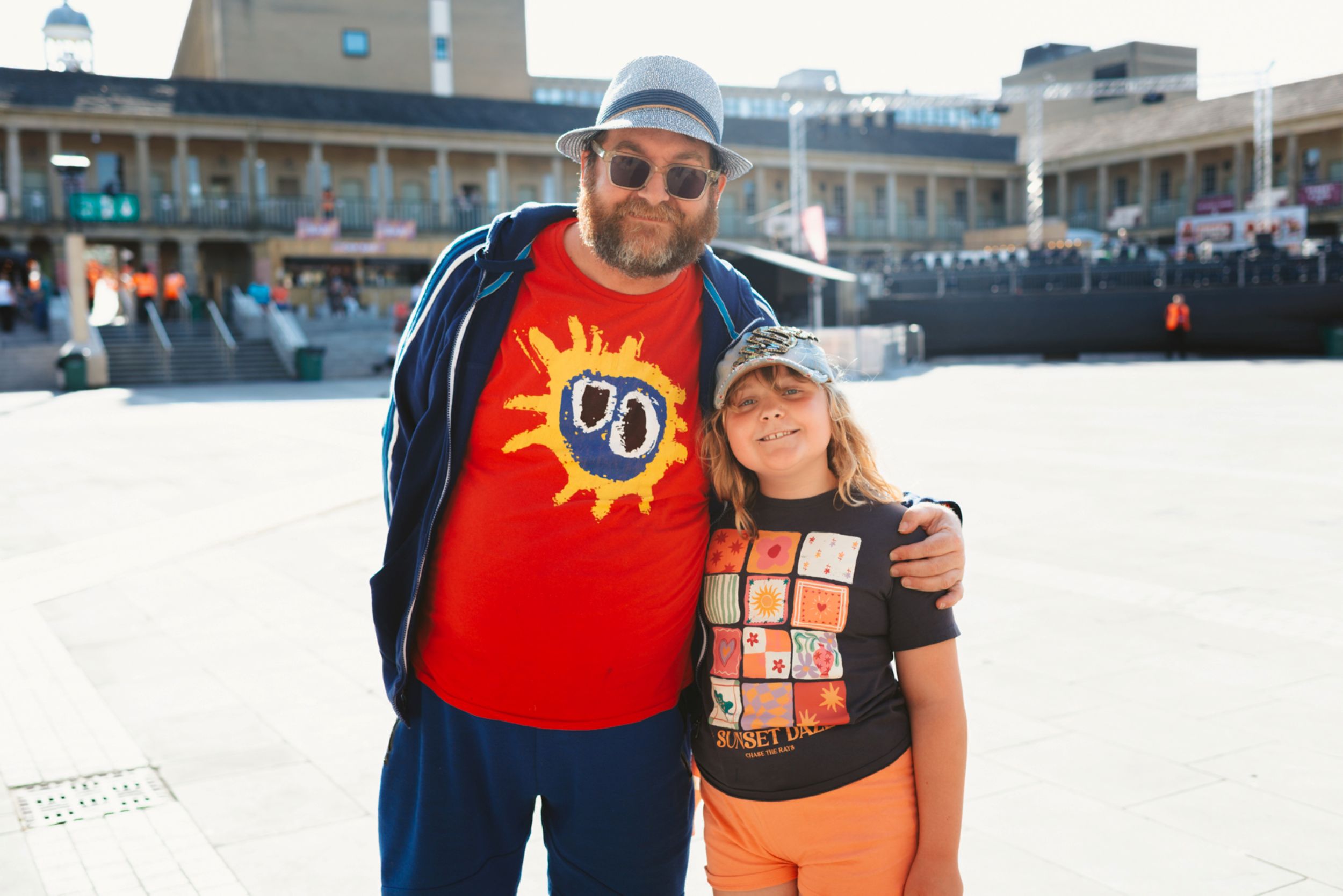 Man and child smiling in sunny Yorkshire courtyard