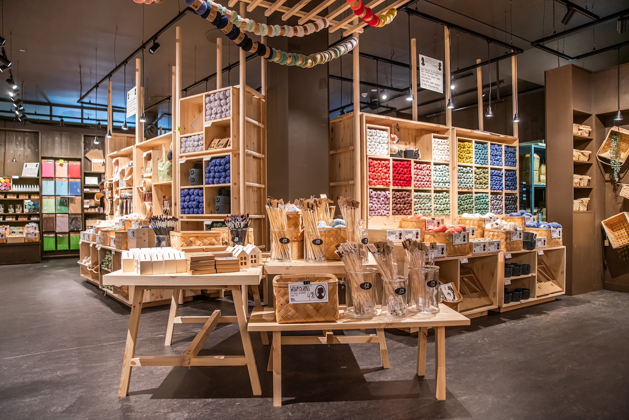 Craft shop interior with wooden shelves and colourful yarns