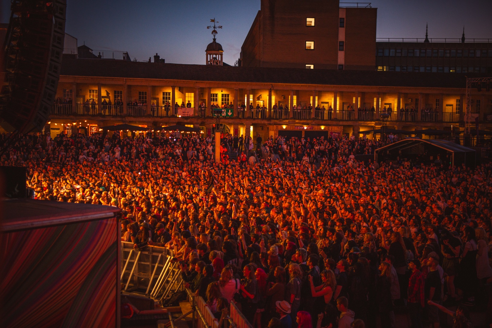 Crowd enjoying a vibrant outdoor evening concert in Yorkshire