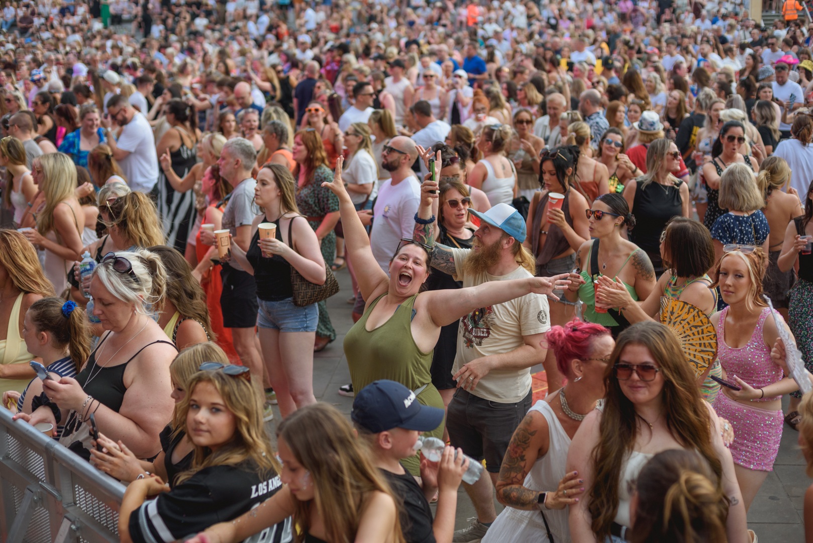 Crowd of people enjoying a lively outdoor festival in Yorkshire - ELLIE SAXX AT THE PIECE HALL