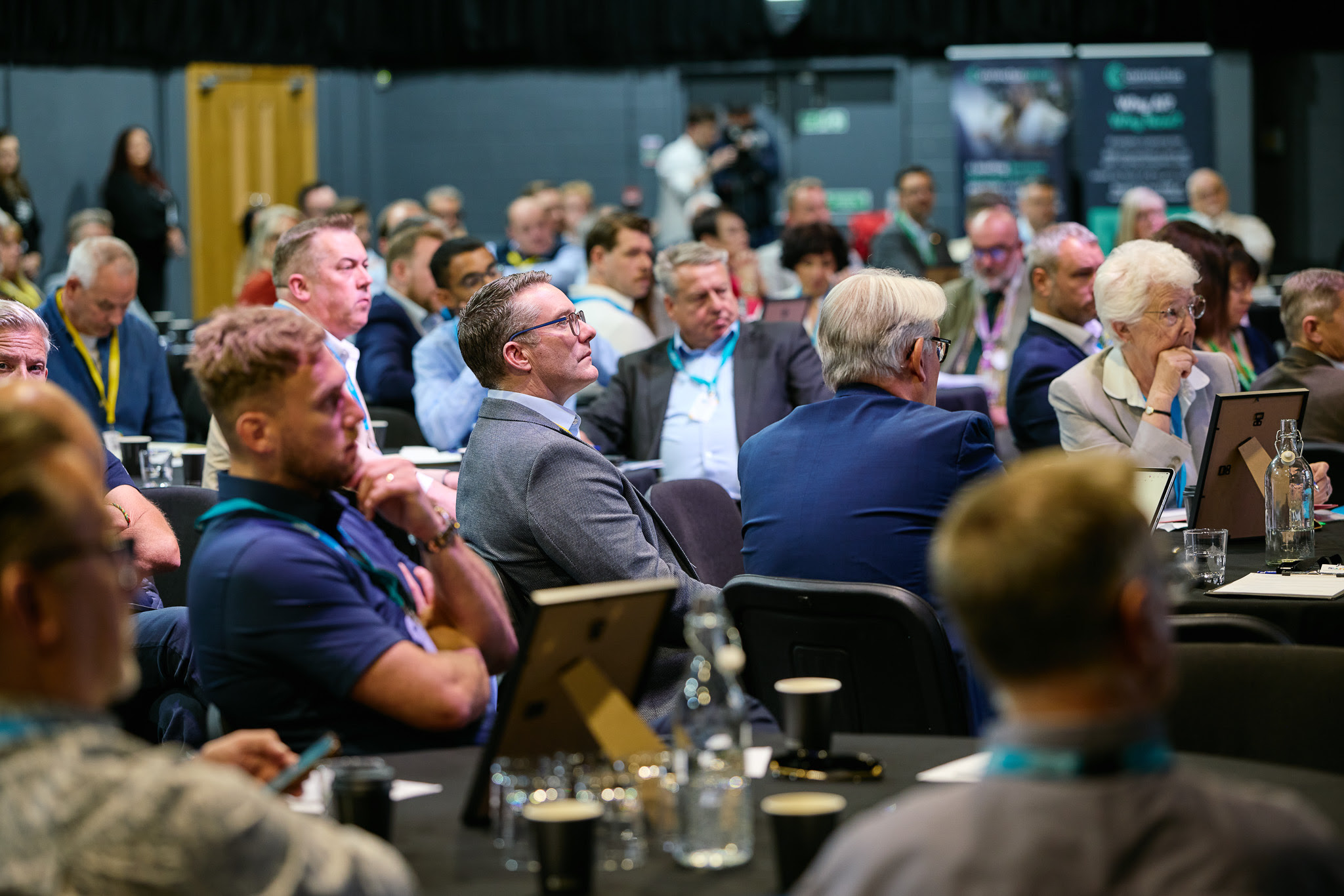 Audience attentively listening to a speaker at a business conference
