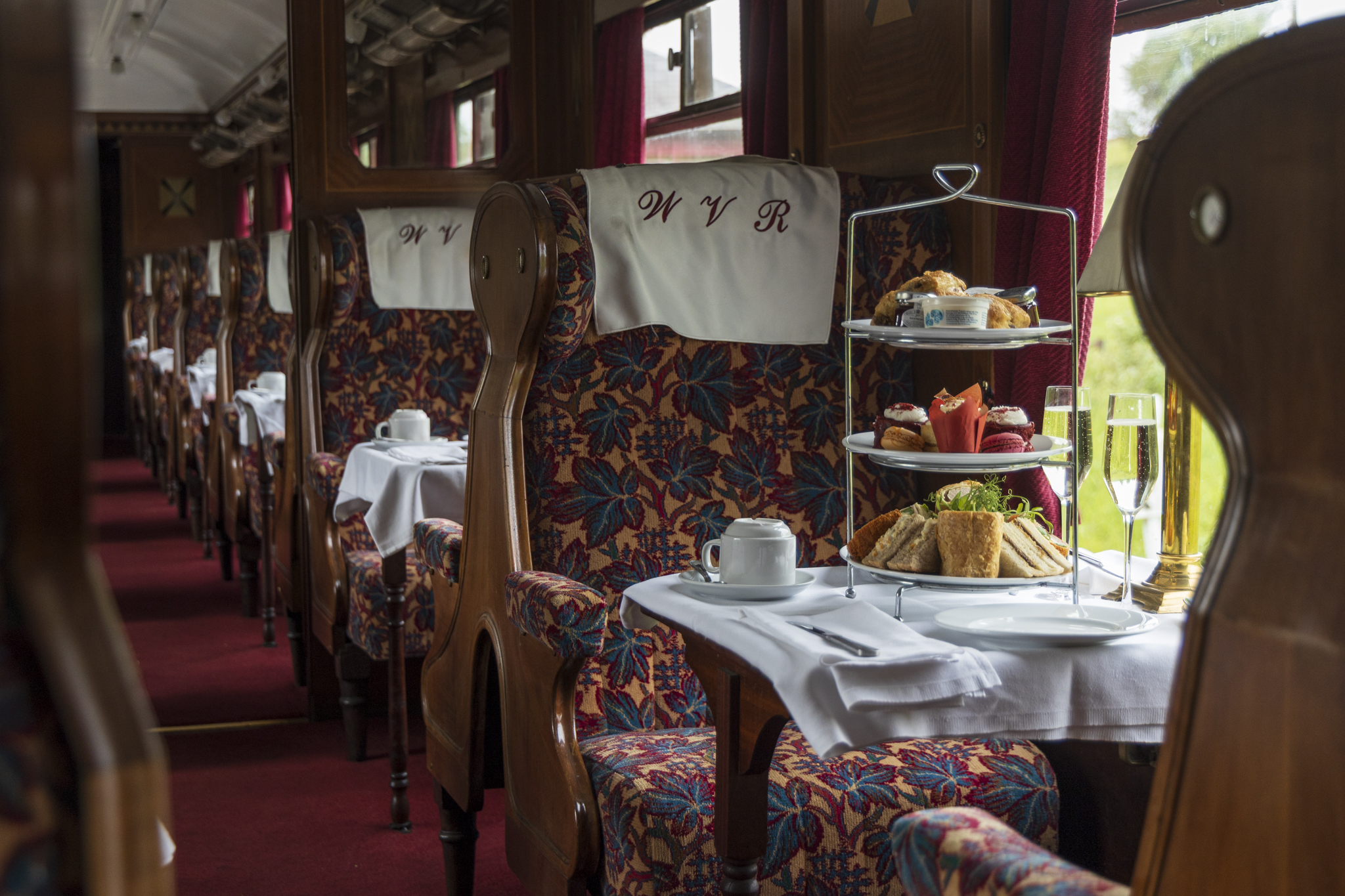 Elegant vintage train carriage with afternoon tea setup
