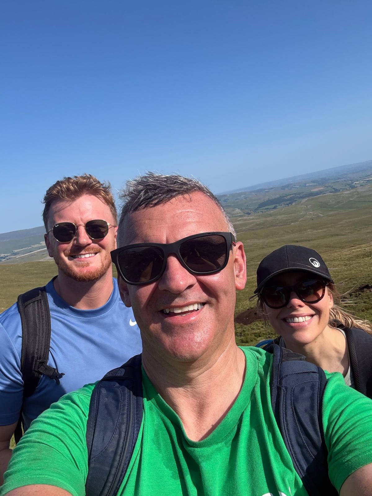 Group of hikers smiling on sunny day in Yorkshire Dales