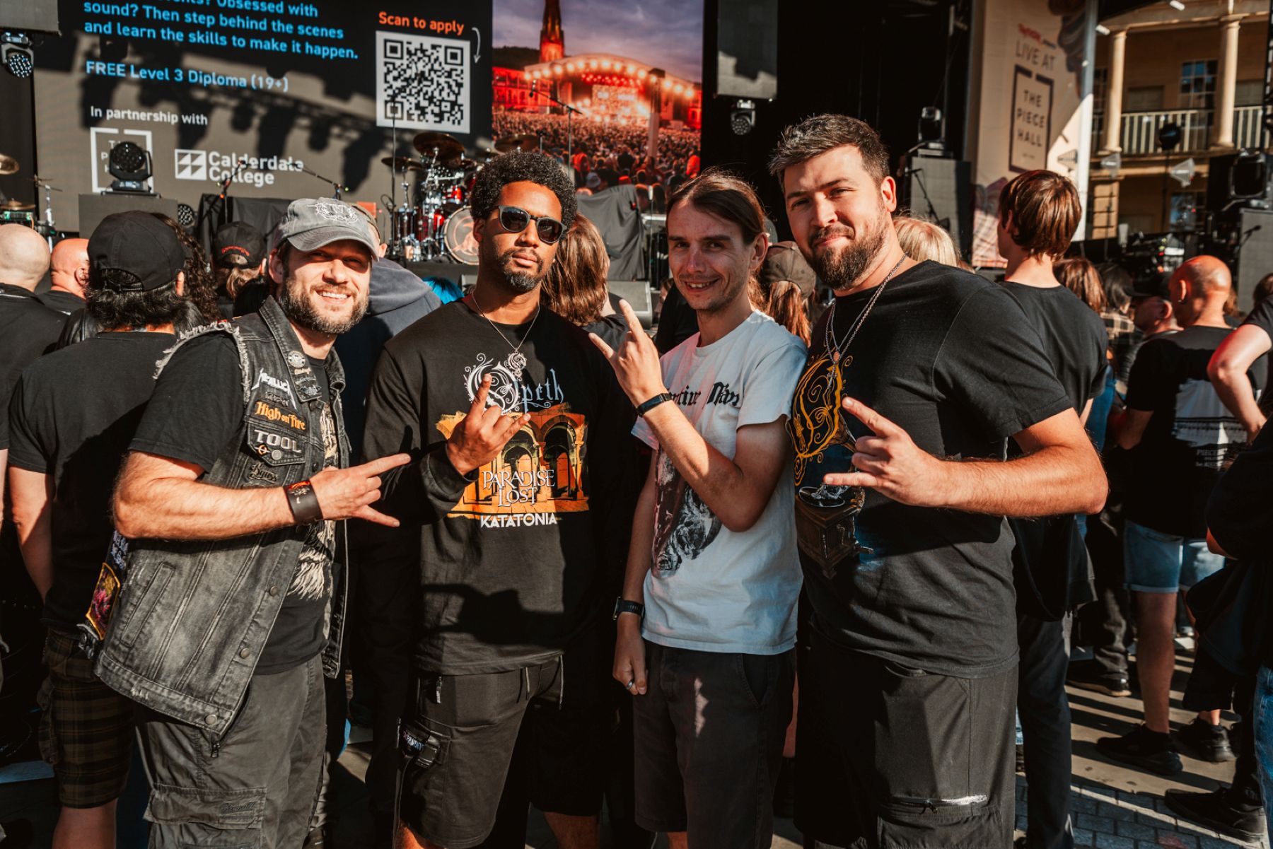 Group of four men at an outdoor music festival stage