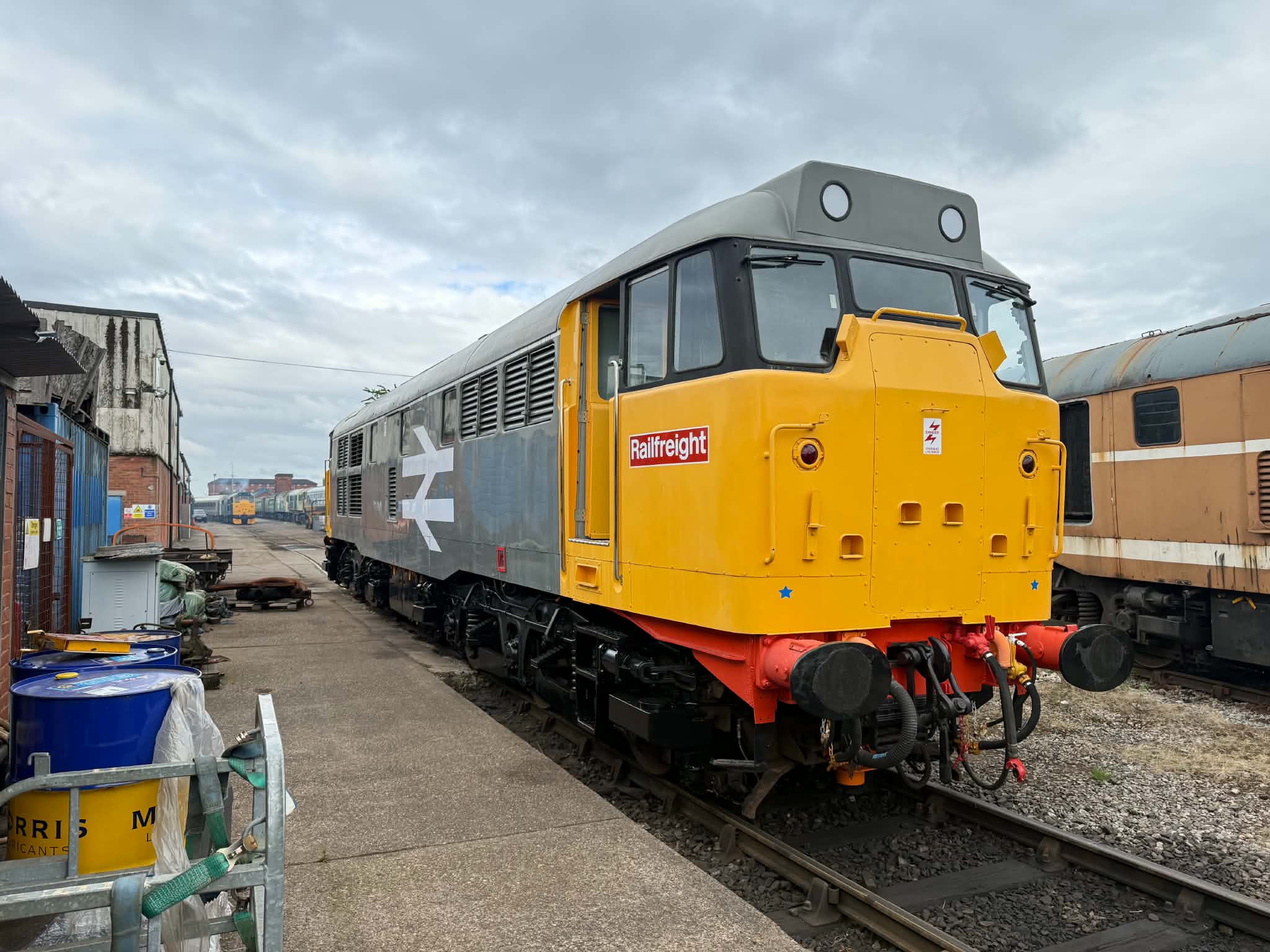Vintage diesel locomotive with yellow front on railway tracks