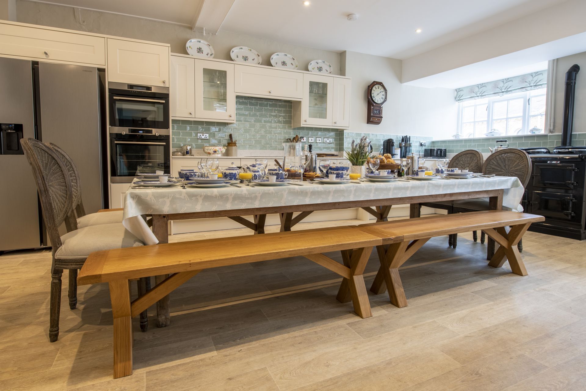 Spacious farmhouse kitchen with wooden tables and chairs