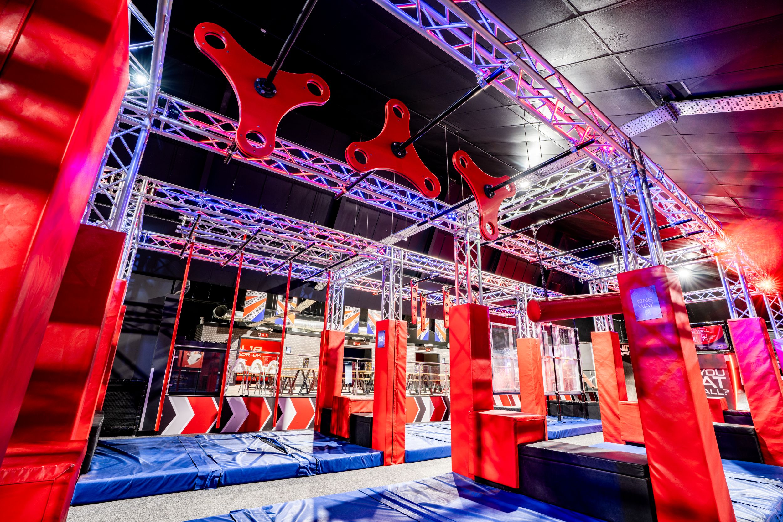 Indoor obstacle course with red and blue padded structures