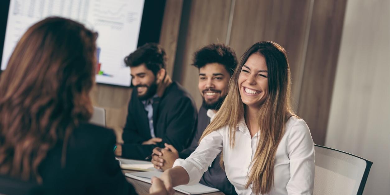 Group of professionals smiling during a business meeting