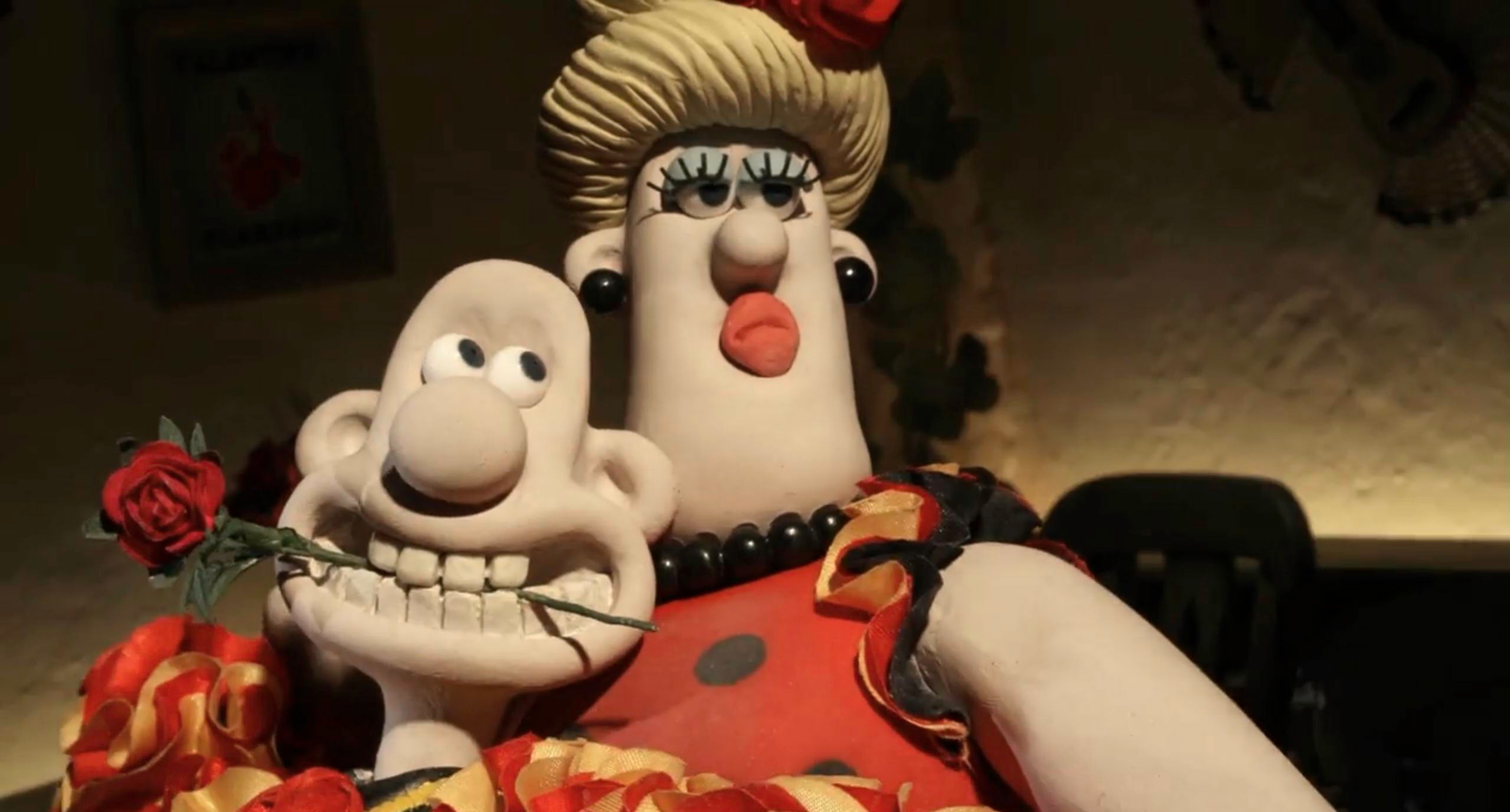 Clay characters with red dress and rose in mouth - The Wrong Trousers