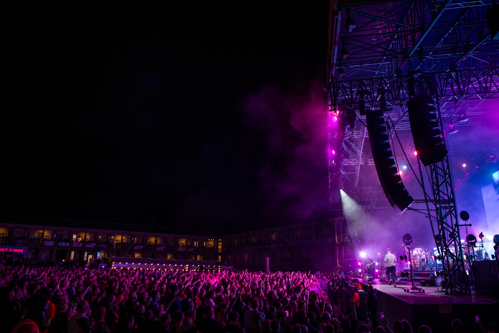 Crowd enjoying a vibrant outdoor concert at night in Yorkshire